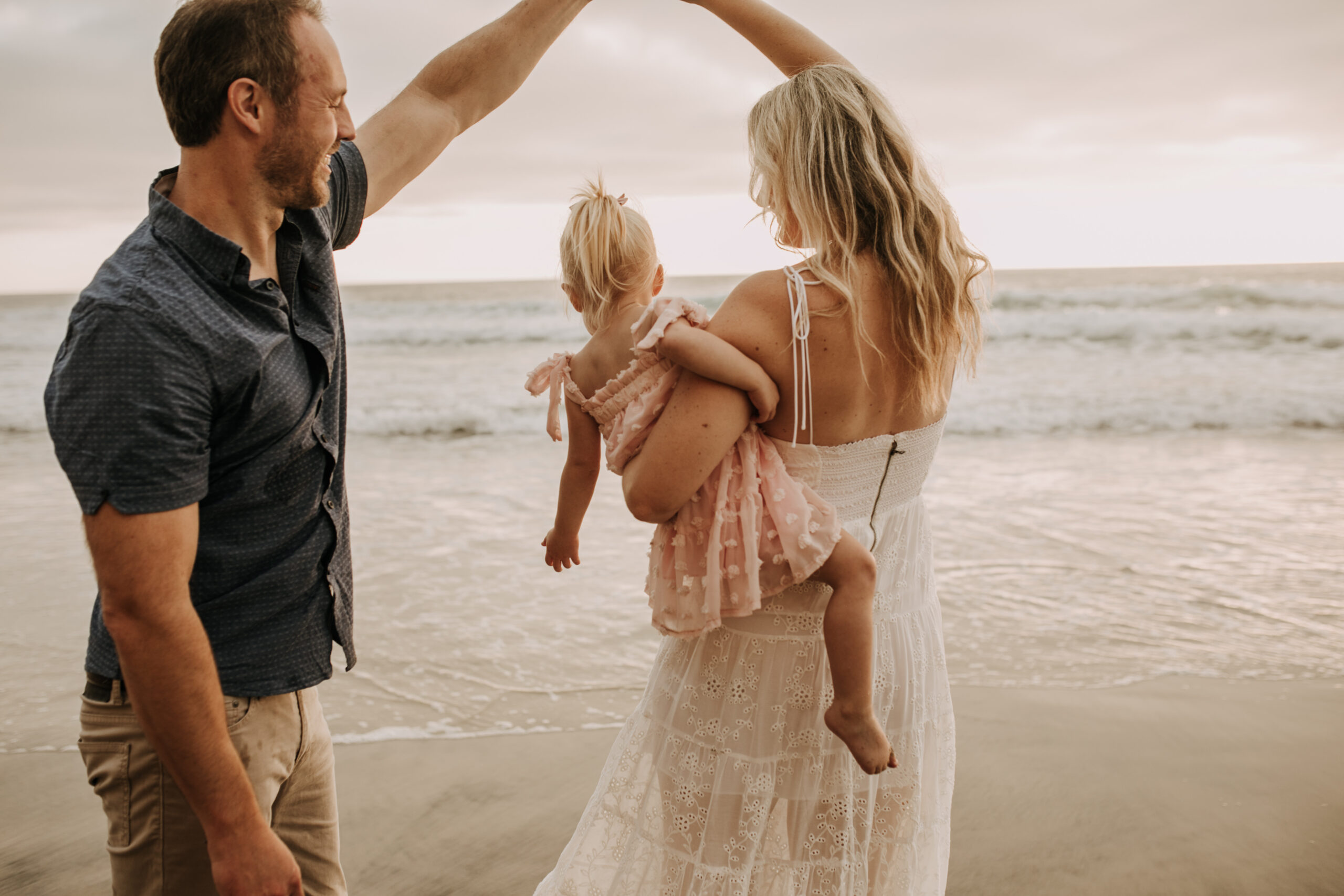 family photos on the beach sunset beach family dad mom baby water golden hour San Diego beach family photos San Diego family photographer