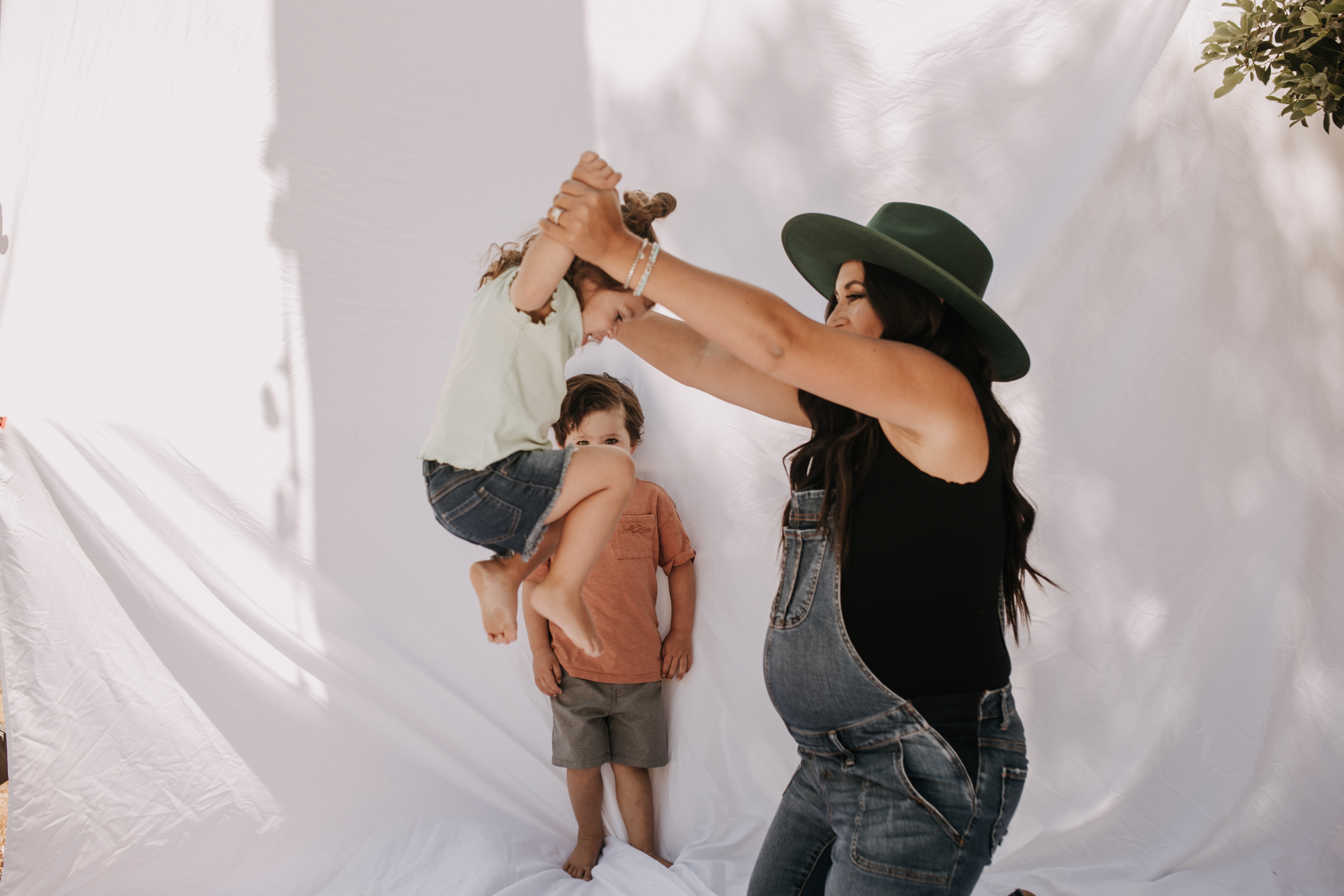 backyard mini session family photos white backdrop outdoor motherhood maternity san diego family photographer