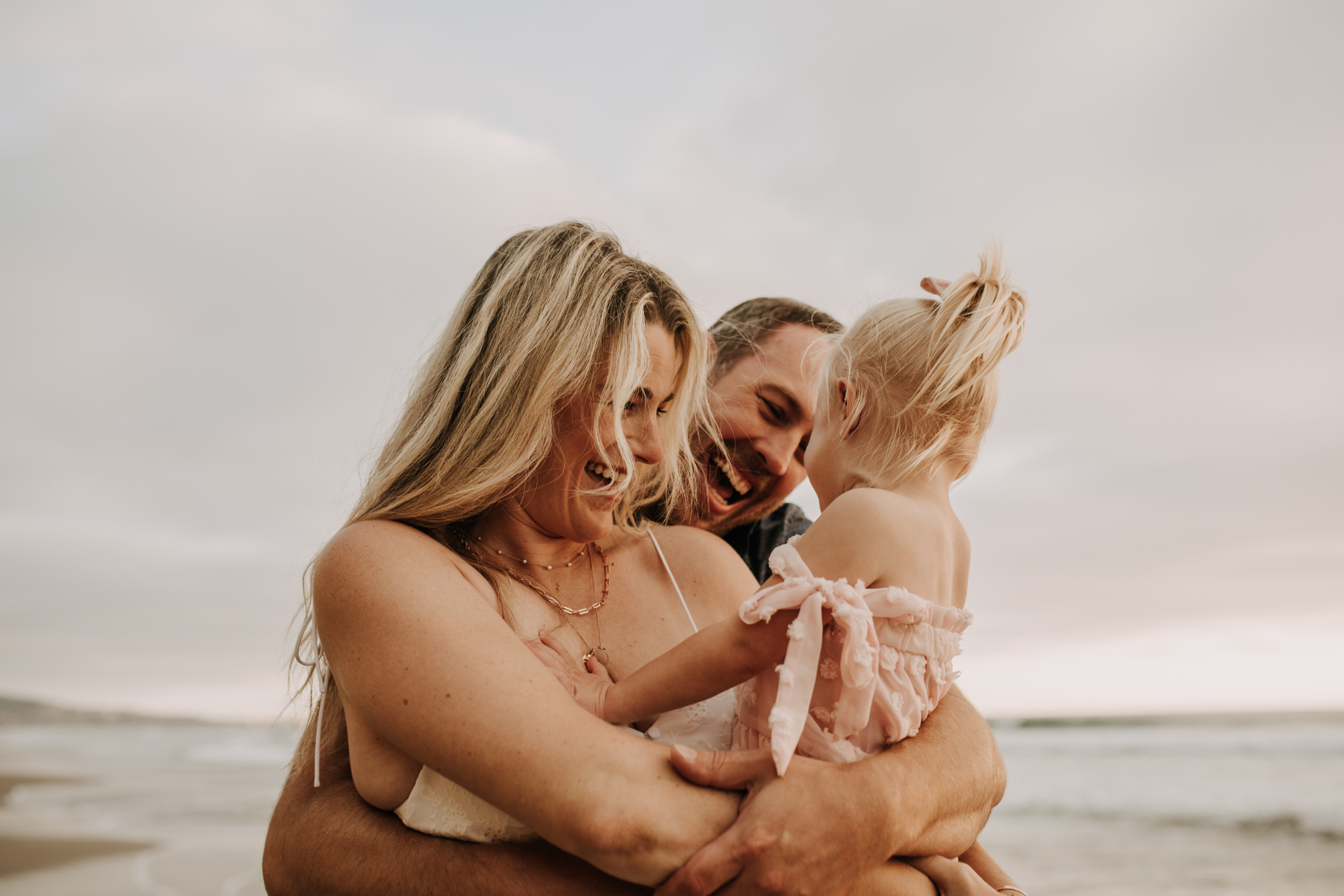 family photos on the beach sunset beach family dad mom baby water golden hour San Diego beach family photos San Diego family photographer