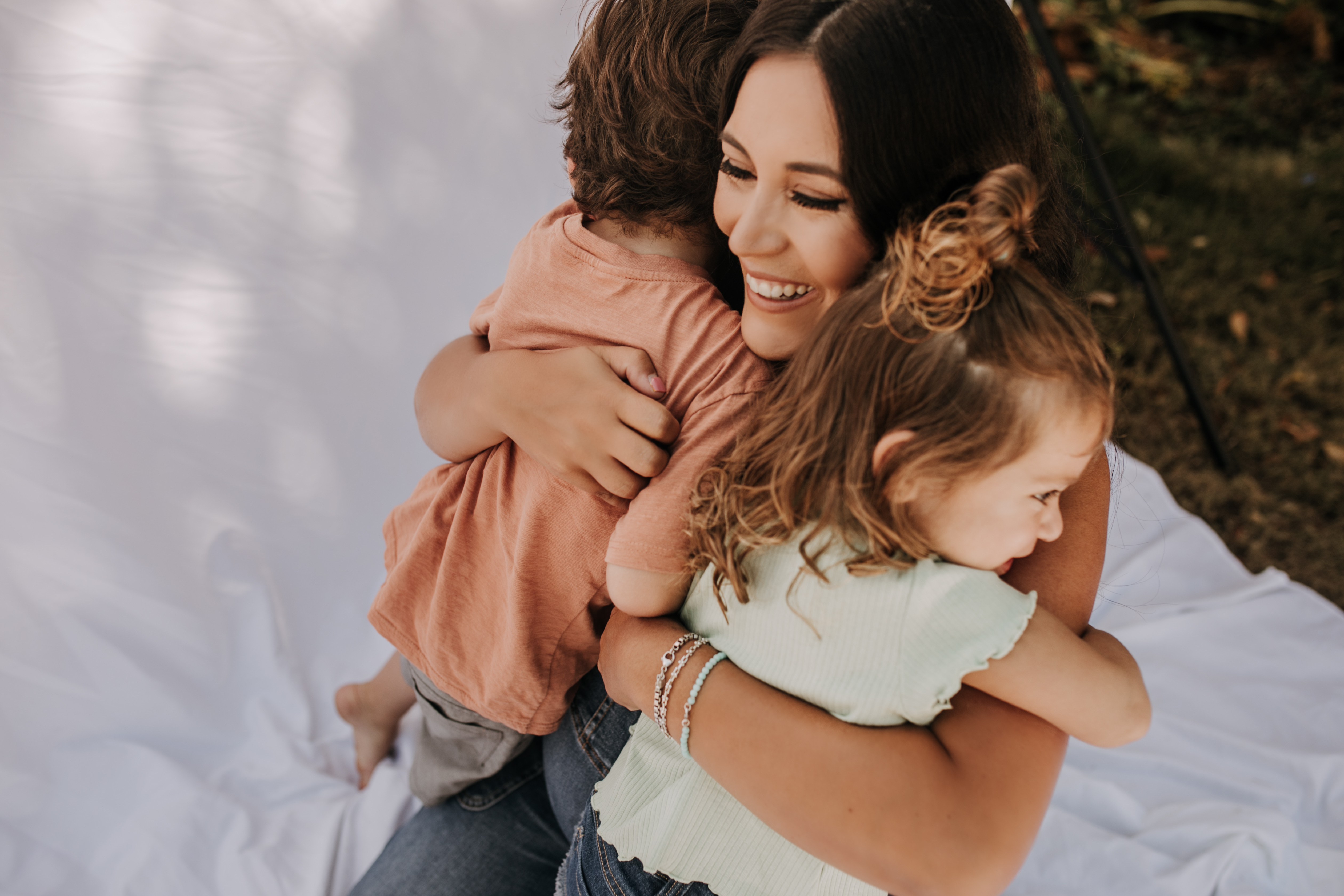 backyard mini session family photos white backdrop outdoor motherhood maternity san diego family photographer