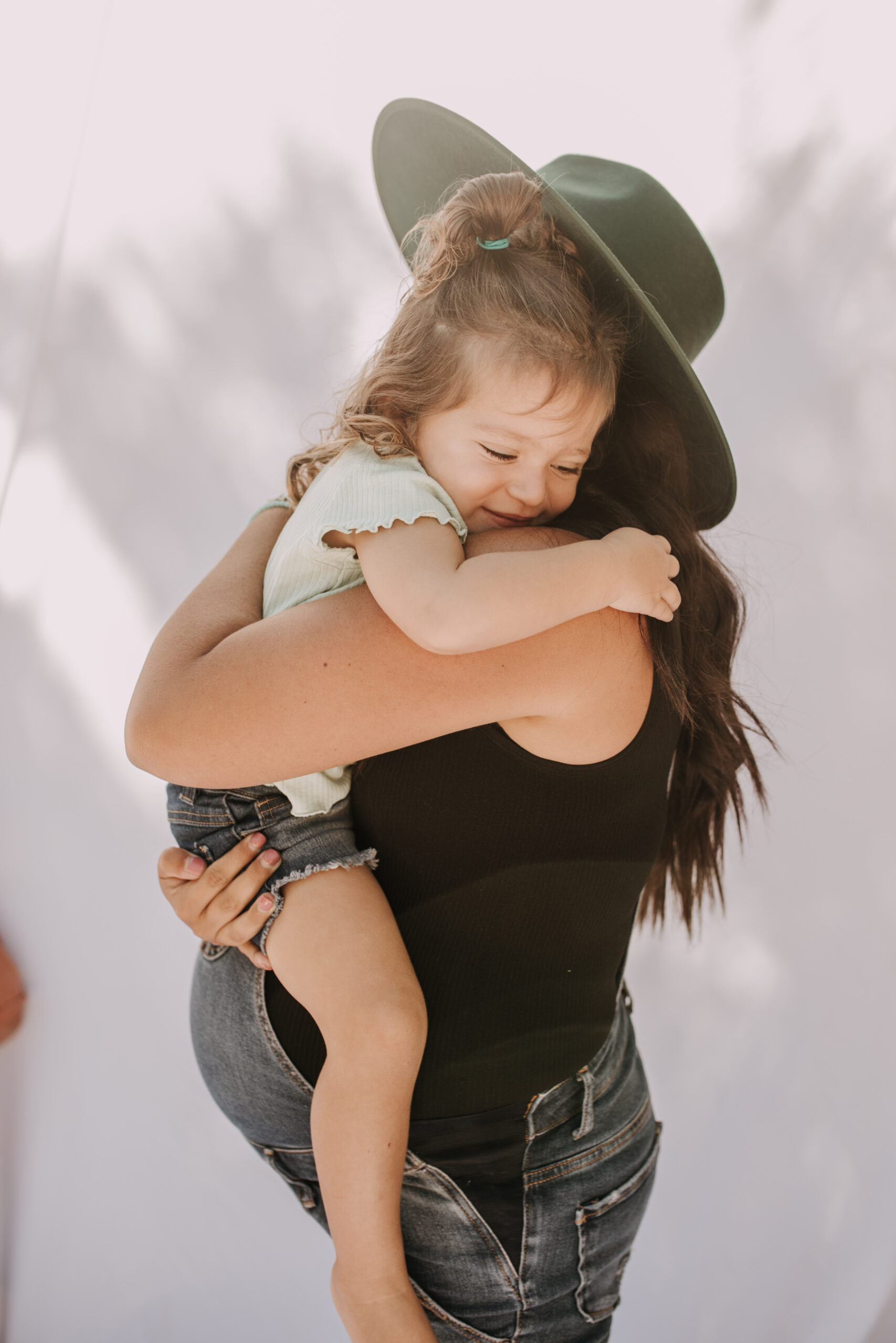 backyard mini session family photos white backdrop outdoor motherhood maternity san diego family photographer