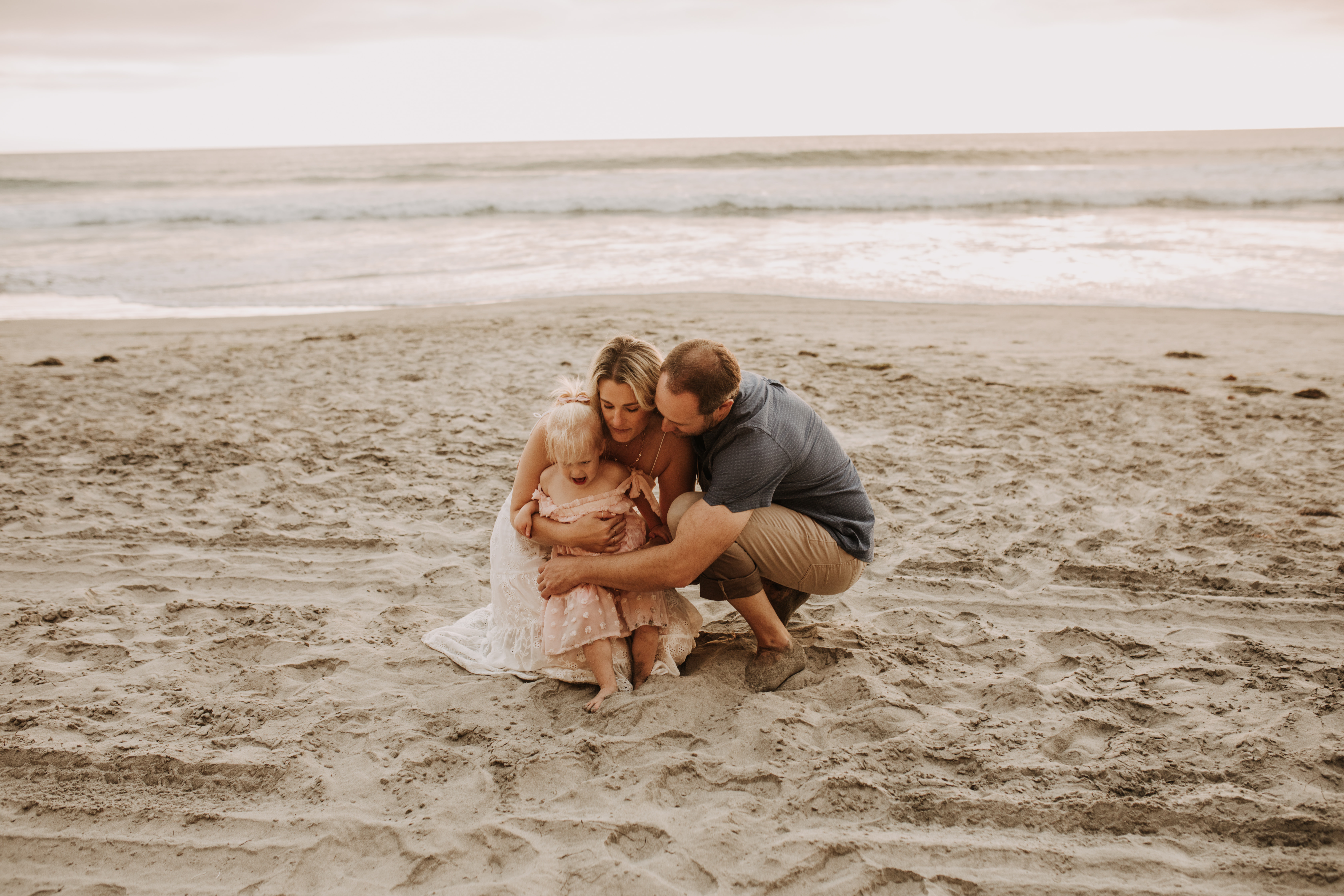 family photos on the beach sunset beach family dad mom baby water golden hour San Diego beach family photos San Diego family photographer