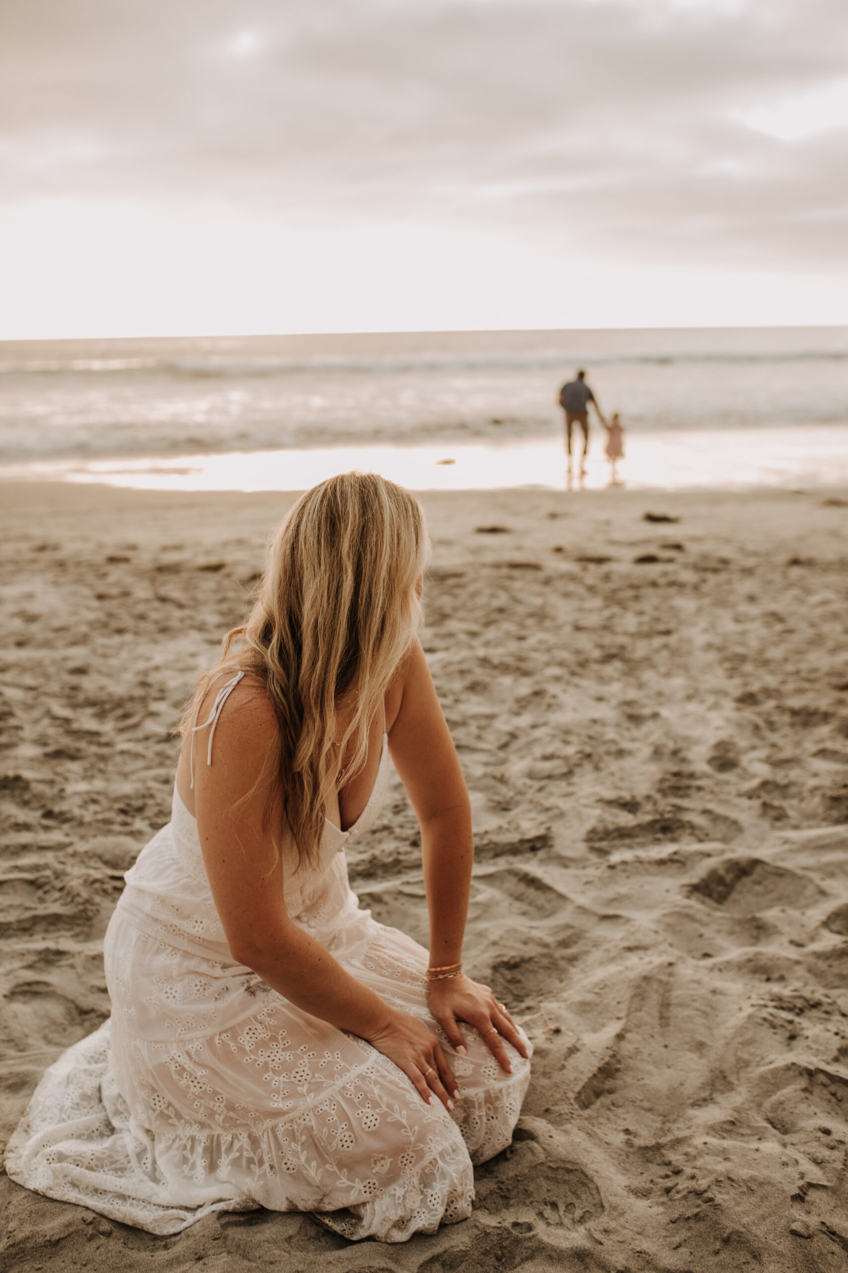 family photos on the beach sunset beach family dad mom baby water golden hour San Diego beach family photos San Diego family photographer