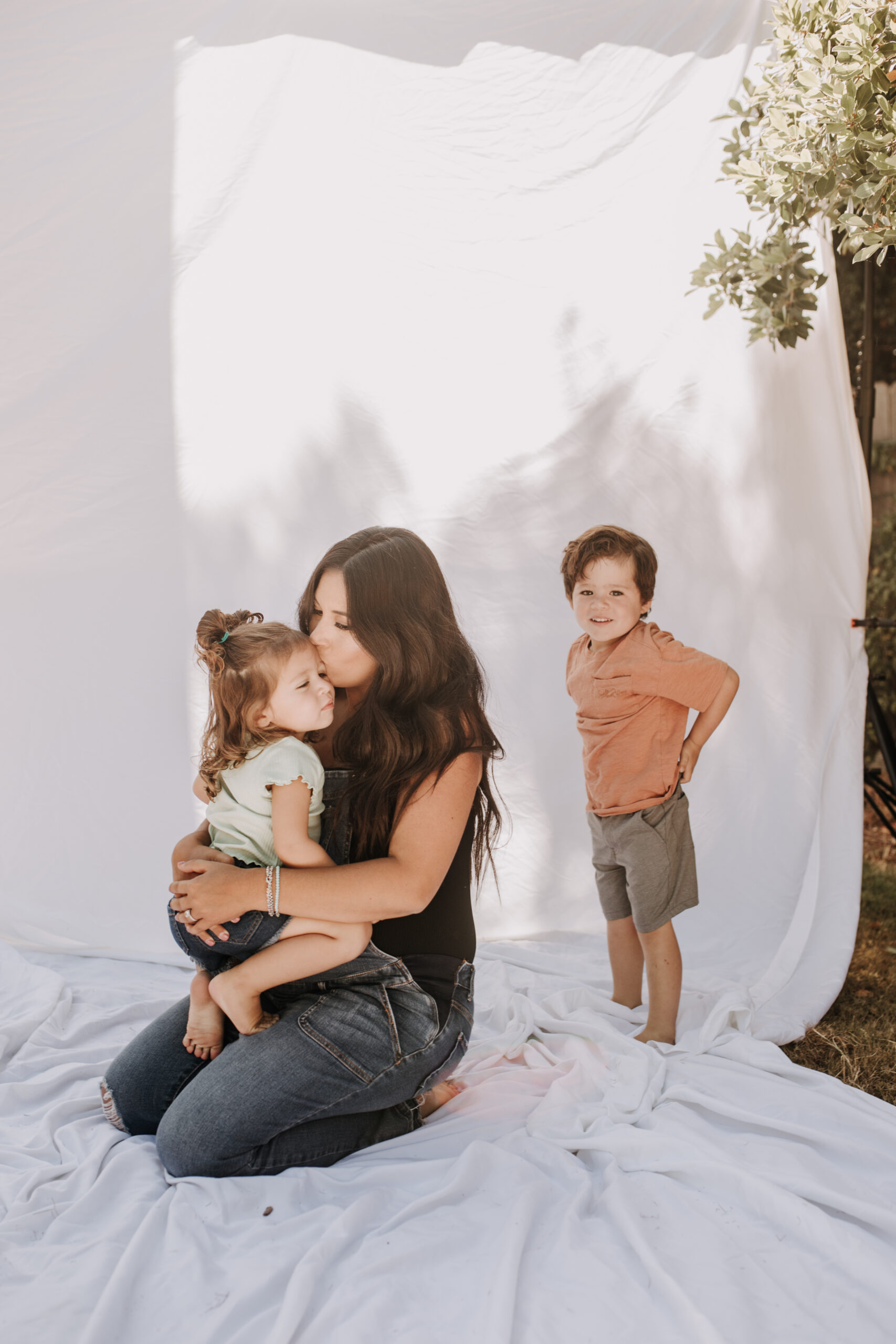 backyard mini session family photos white backdrop outdoor motherhood maternity san diego family photographer