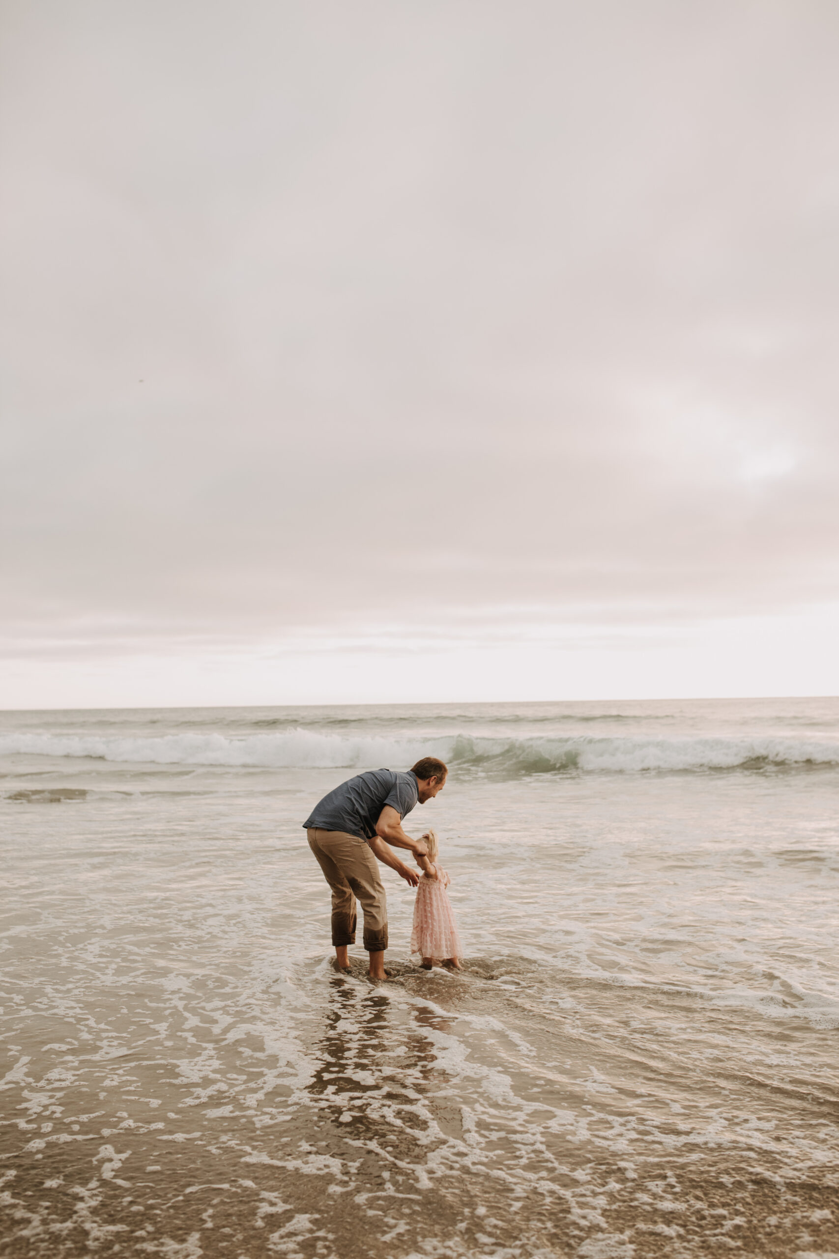 family photos on the beach sunset beach family dad mom baby water golden hour San Diego beach family photos San Diego family photographer