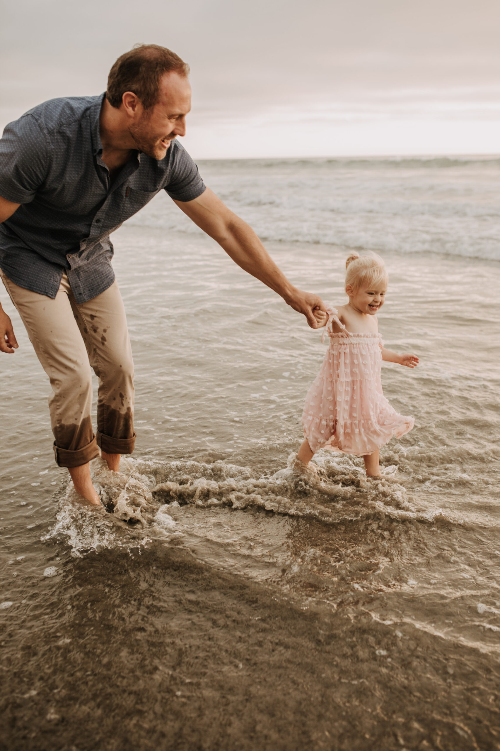 family photos on the beach sunset beach family dad mom baby water golden hour San Diego beach family photos San Diego family photographer