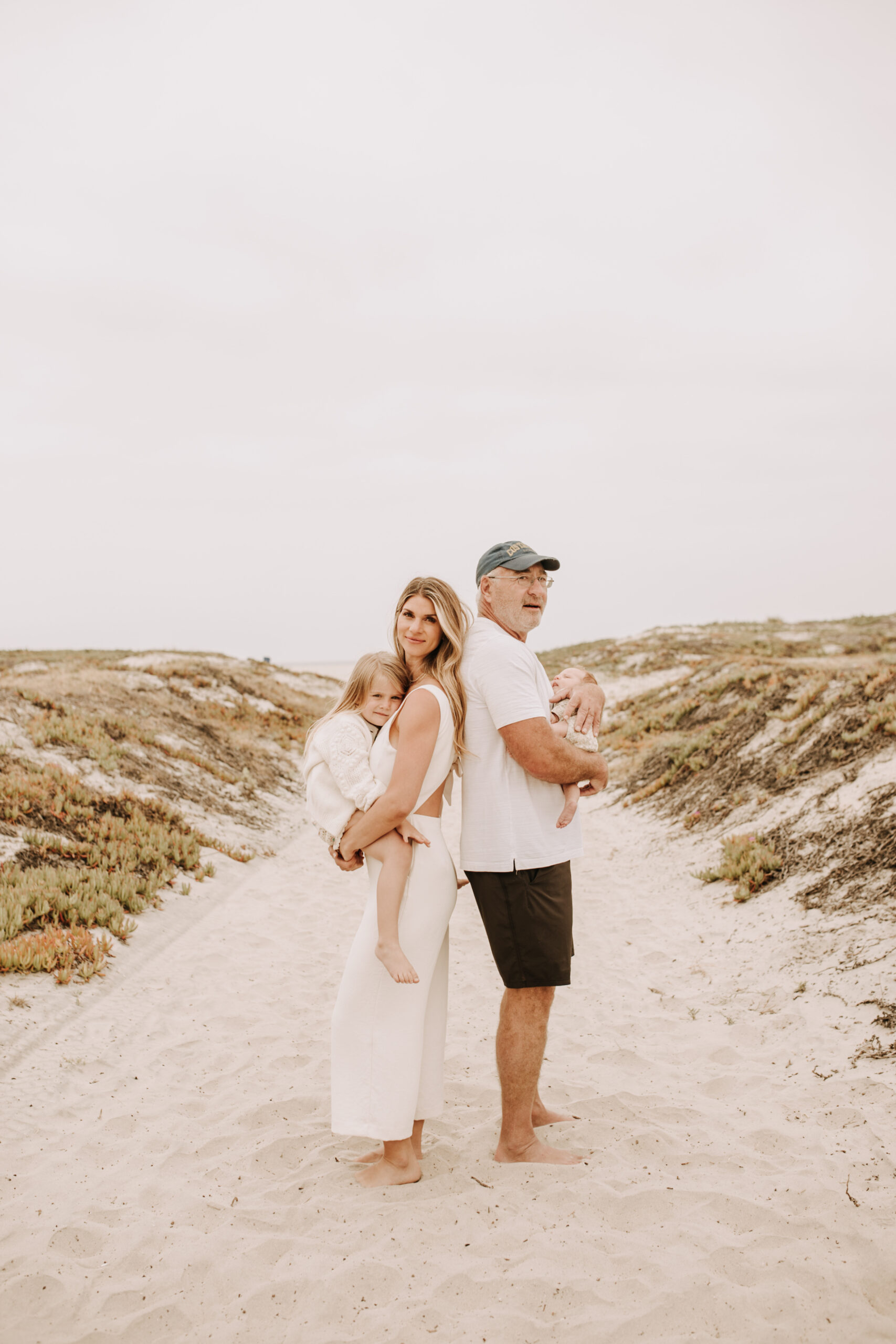 warm toned neutral color outdoor family photos beach day family photos newborn photos infant family cloudy day san digo family photographer Sabrina Kinsella