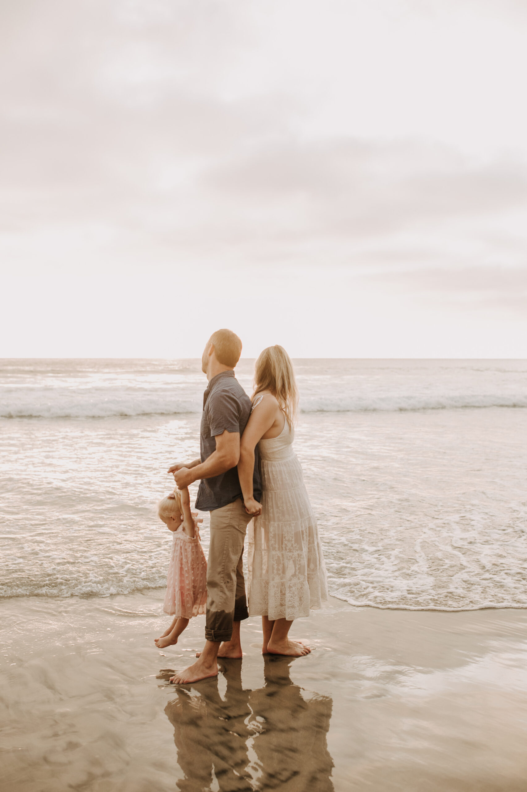 family photos on the beach sunset beach family dad mom baby water golden hour San Diego beach family photos San Diego family photographer