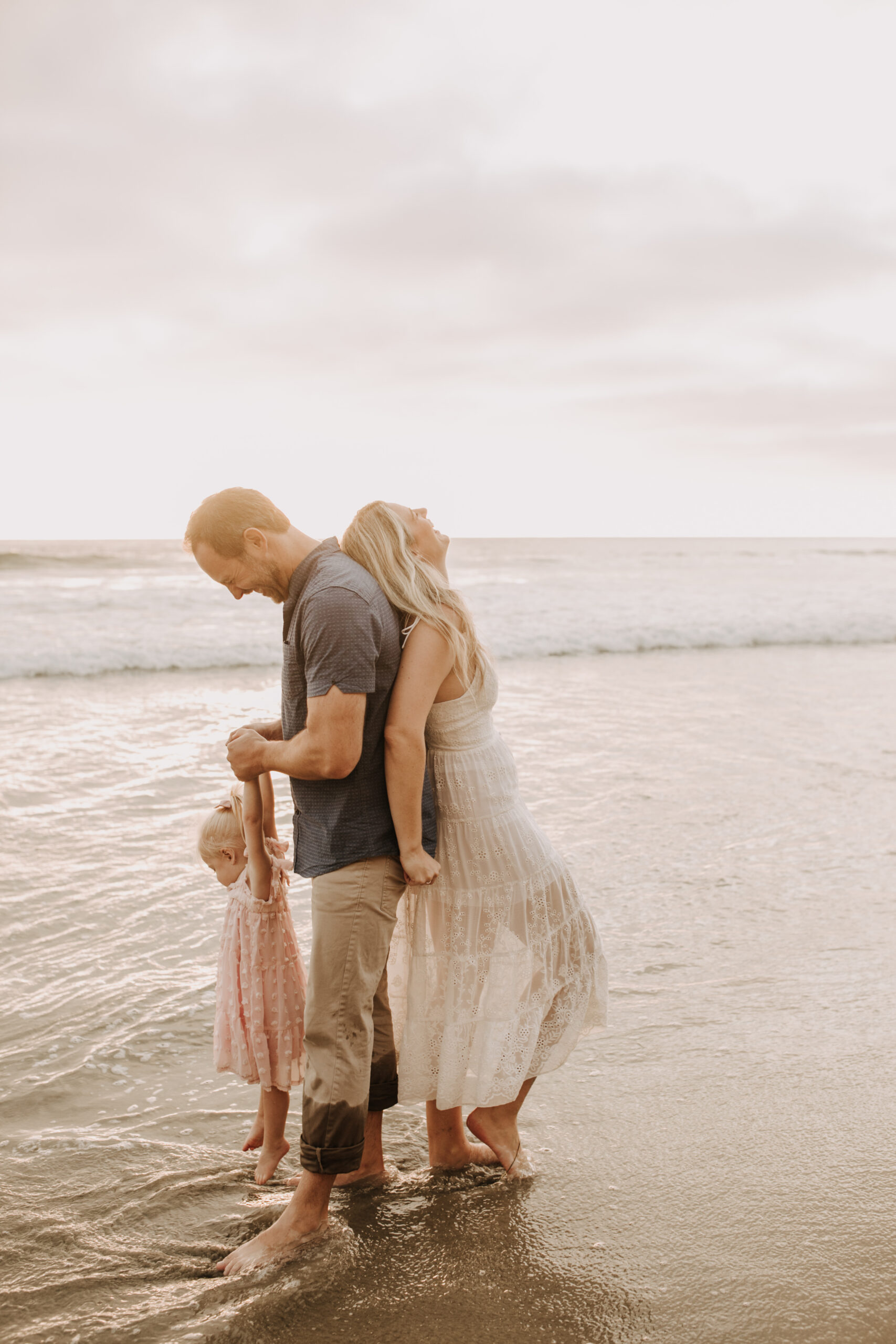 family photos on the beach sunset beach family dad mom baby water golden hour San Diego beach family photos San Diego family photographer