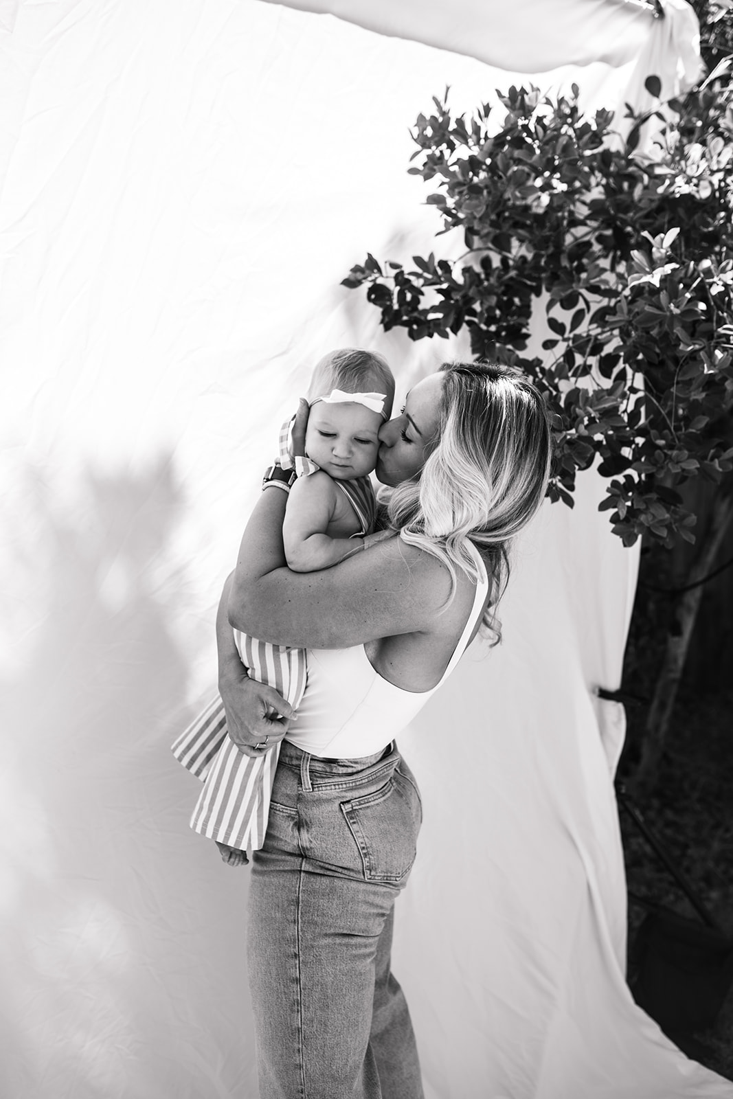 outdoor family photos San Diego family photographer candid family photos mom and dad and baby backyard mini session white backdrop photography