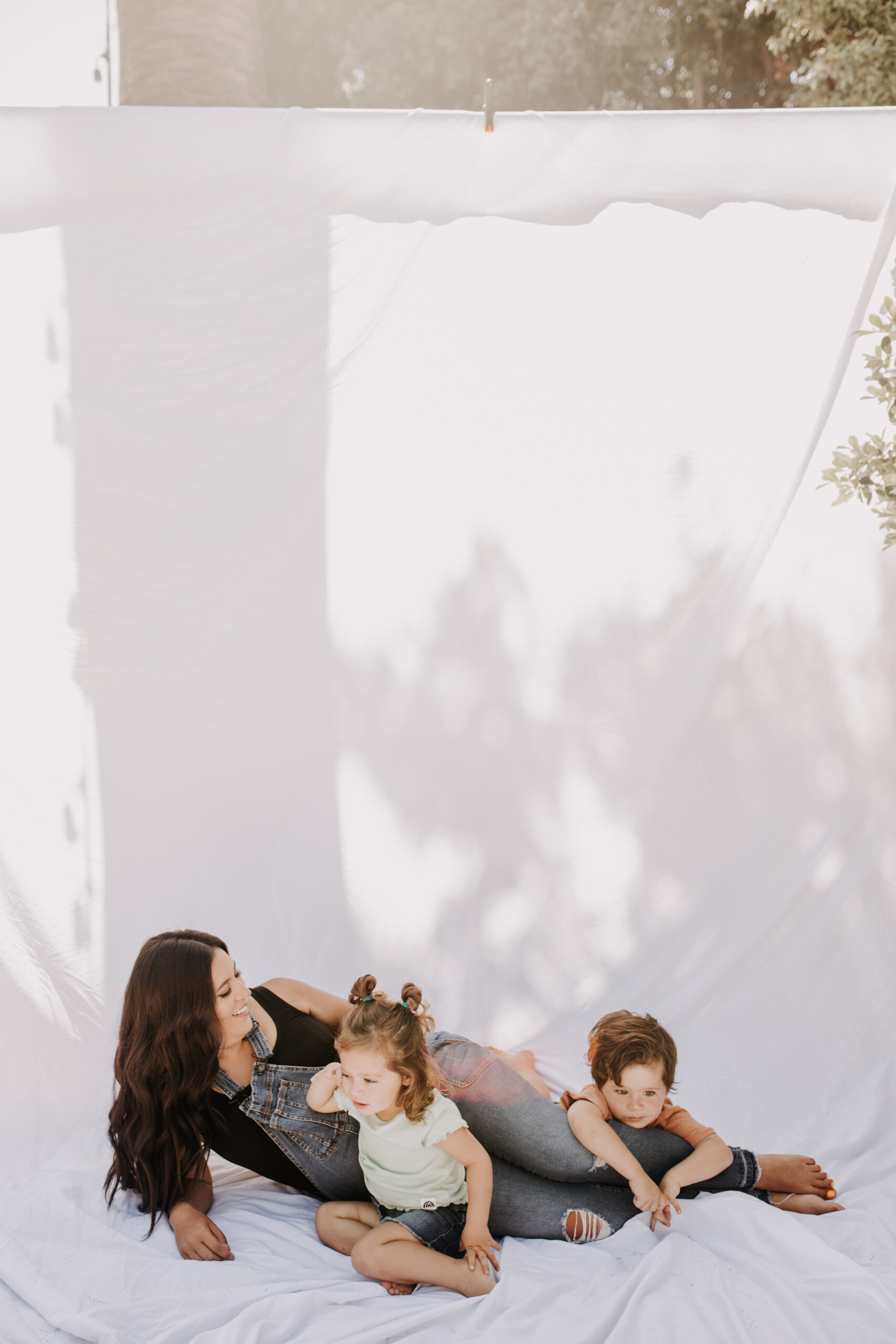 backyard mini session family photos white backdrop outdoor motherhood maternity san diego family photographer