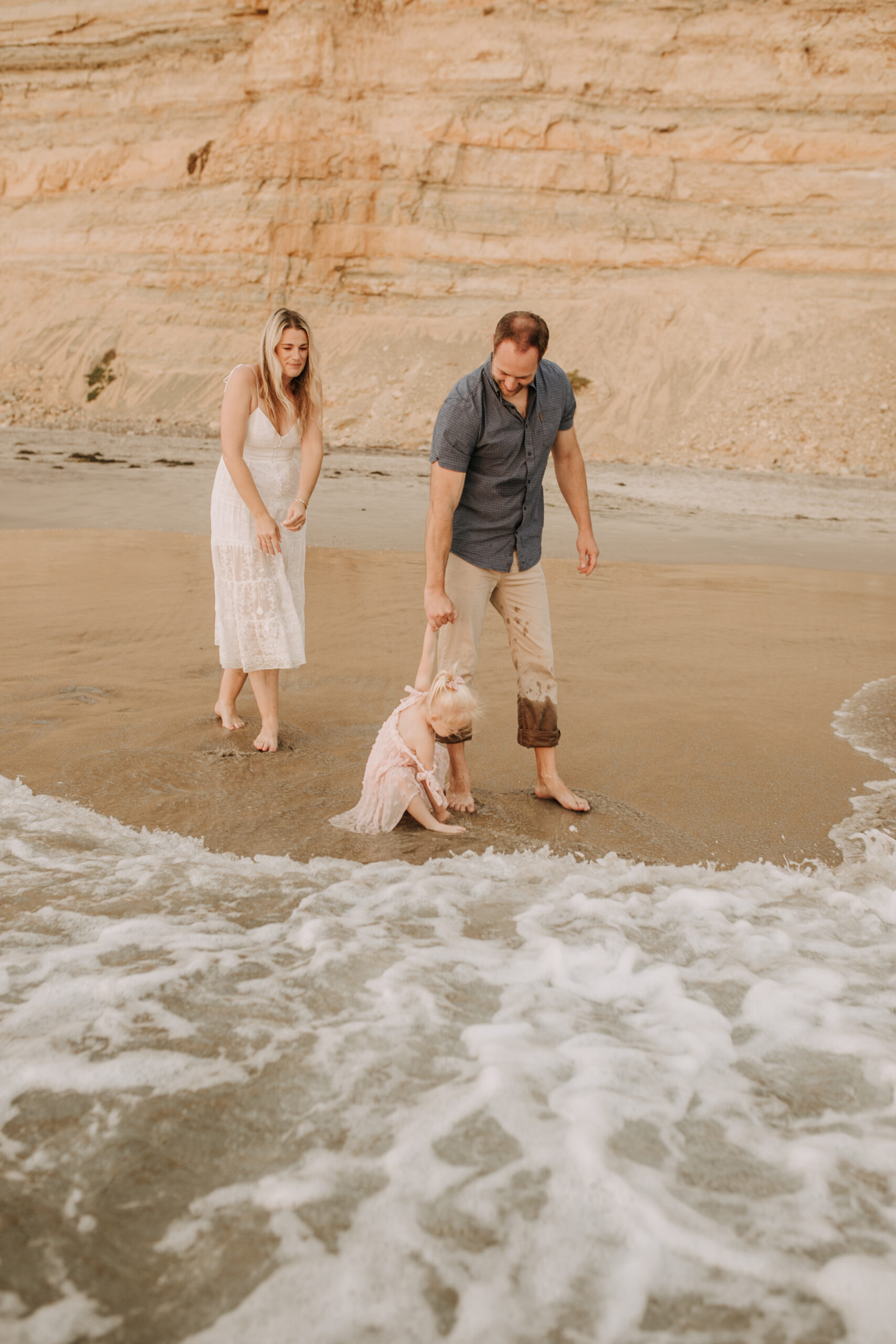 family photos on the beach sunset beach family dad mom baby water golden hour San Diego beach family photos San Diego family photographer