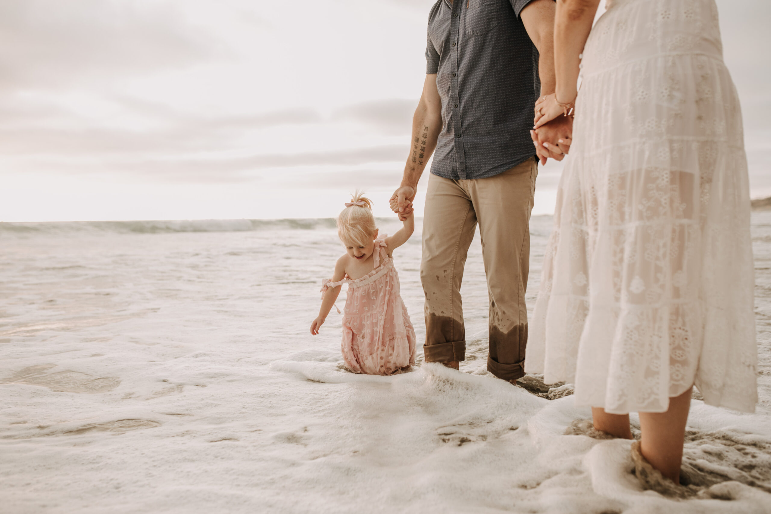 family photos on the beach sunset beach family dad mom baby water golden hour San Diego beach family photos San Diego family photographer