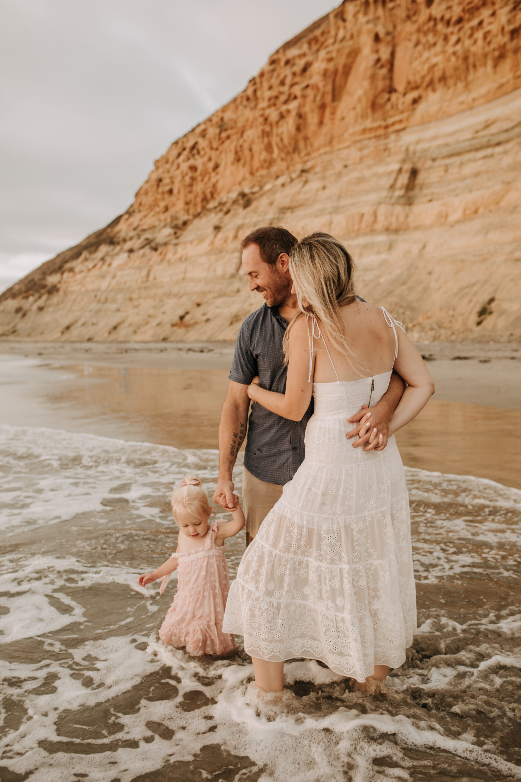 family photos on the beach sunset beach family dad mom baby water golden hour San Diego beach family photos San Diego family photographer