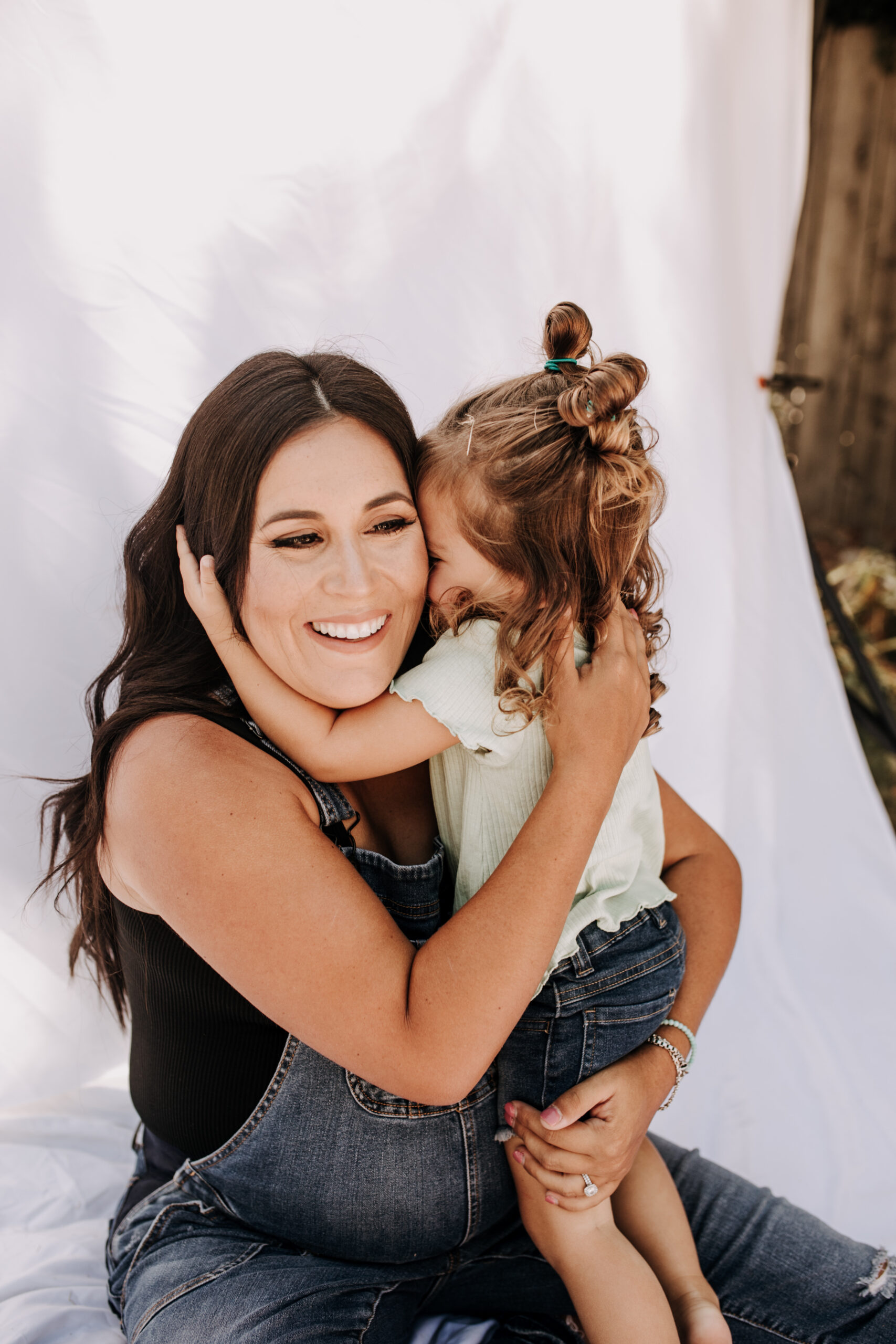 backyard mini session family photos white backdrop outdoor motherhood maternity san diego family photographer