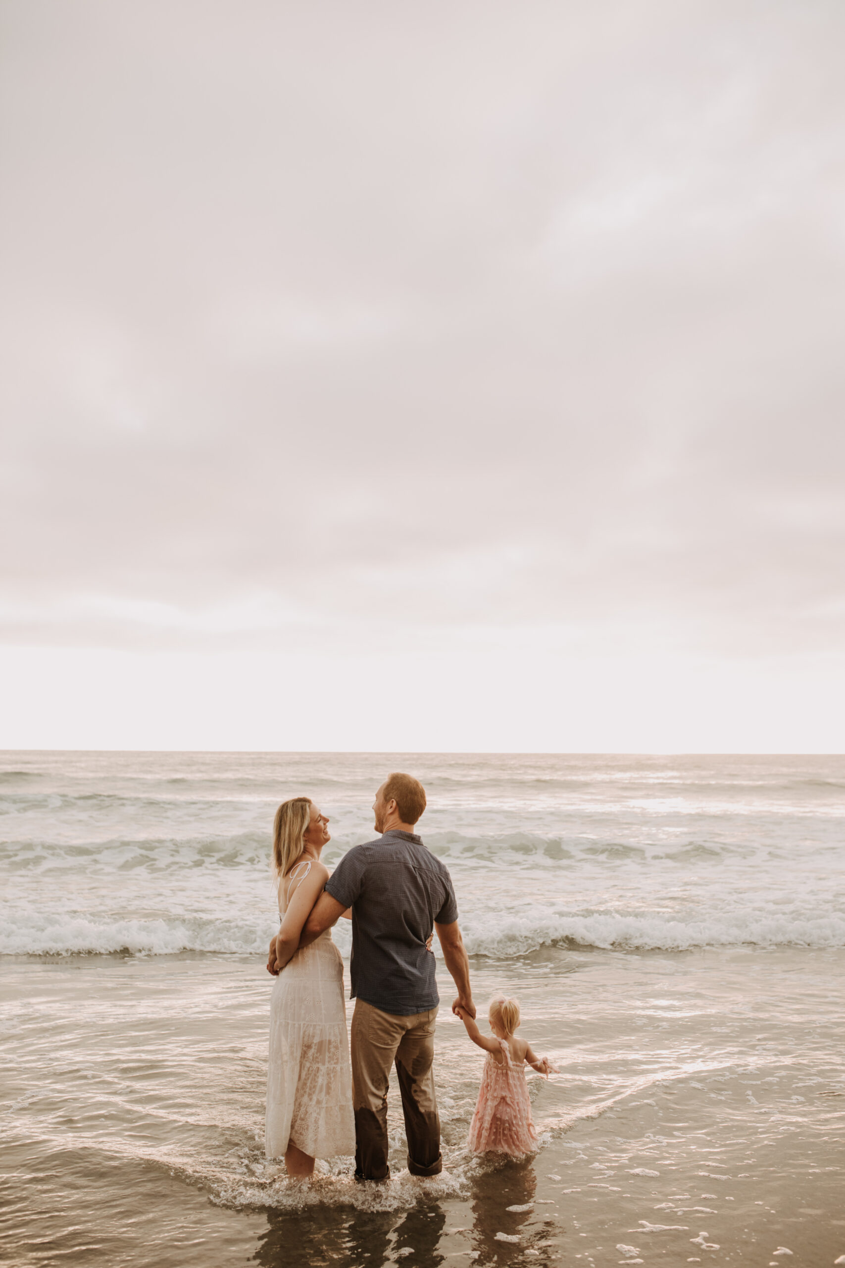 family photos on the beach sunset beach family dad mom baby water golden hour San Diego beach family photos San Diego family photographer