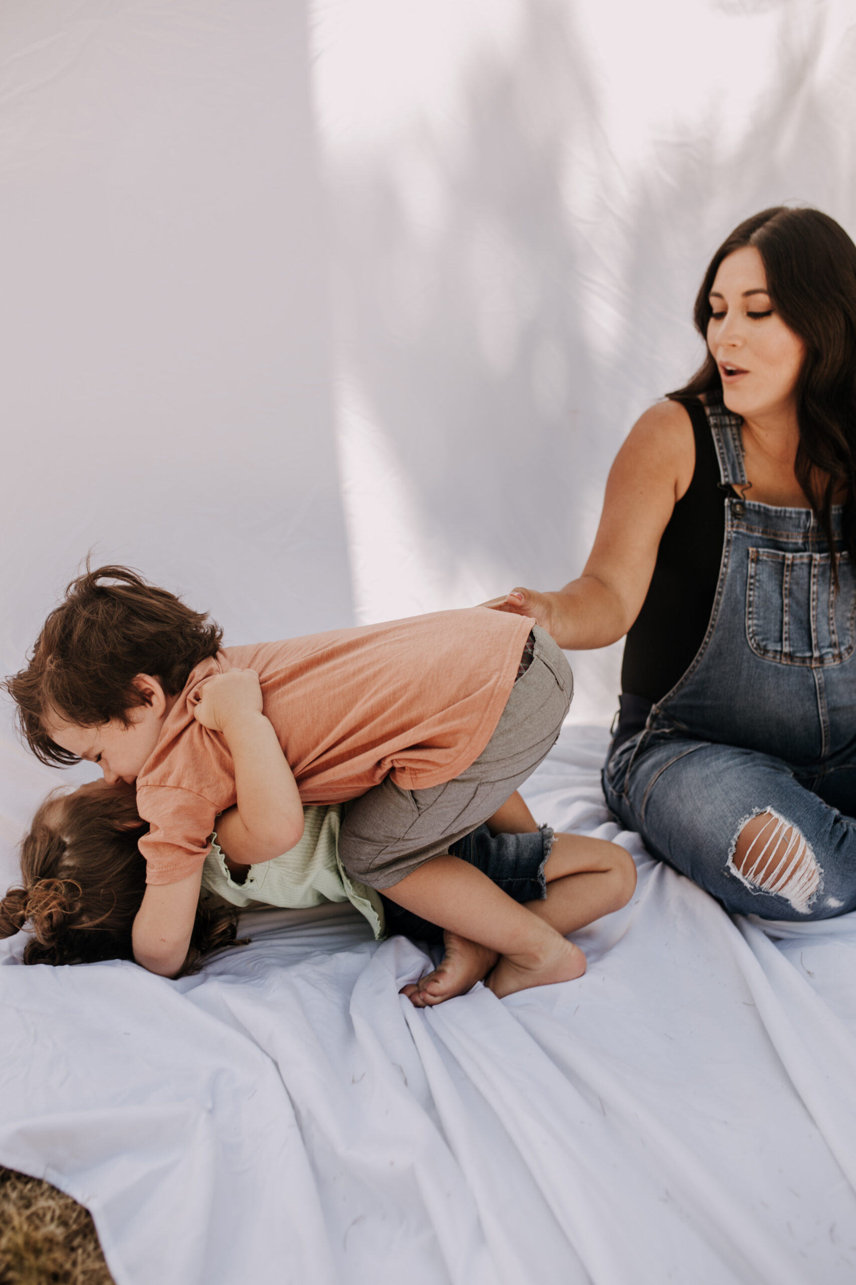 backyard mini session family photos white backdrop outdoor motherhood maternity san diego family photographer