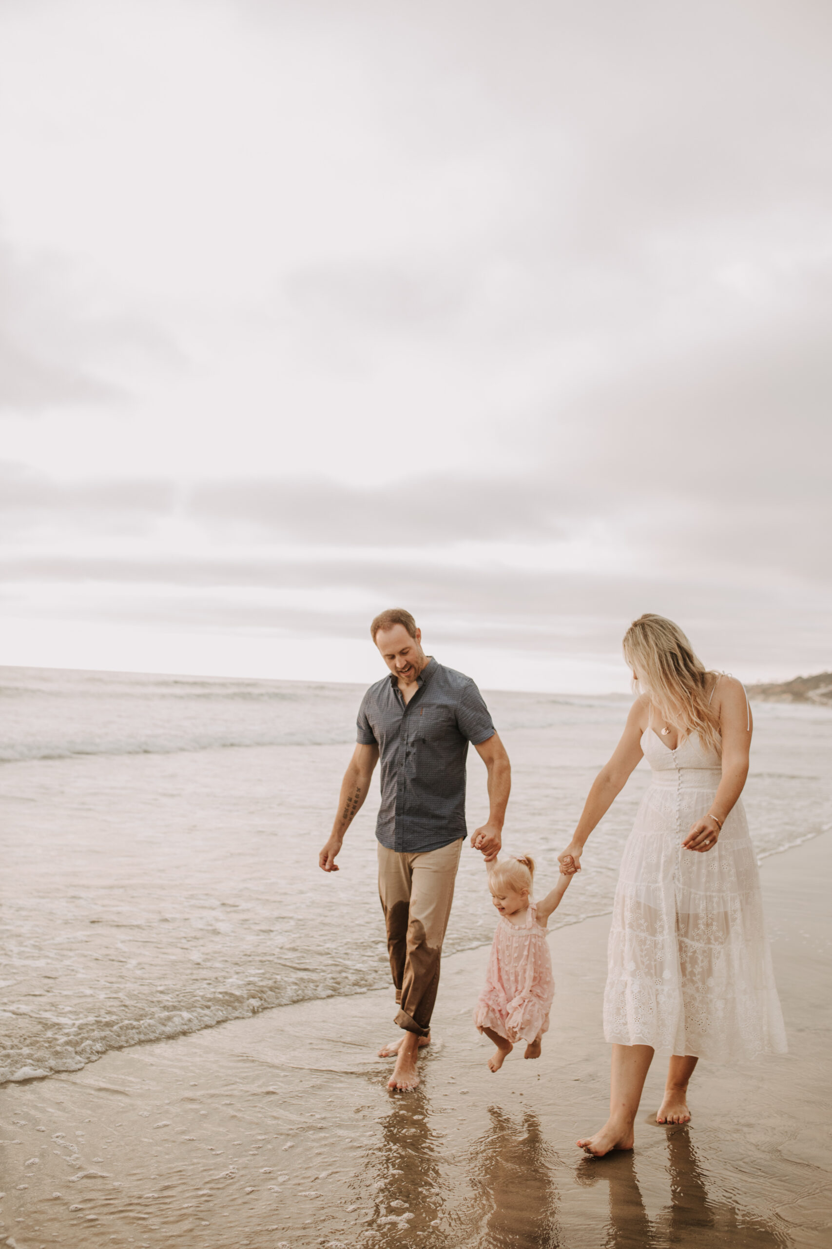 family photos on the beach sunset beach family dad mom baby water golden hour San Diego beach family photos San Diego family photographer