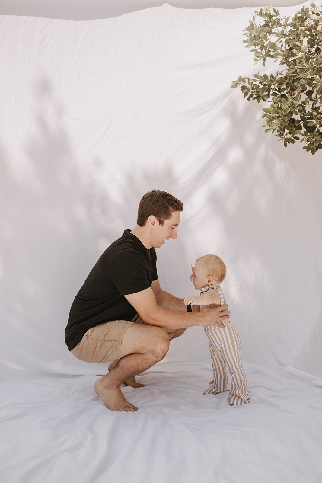 outdoor family photos San Diego family photographer candid family photos mom and dad and baby backyard mini session white backdrop photography