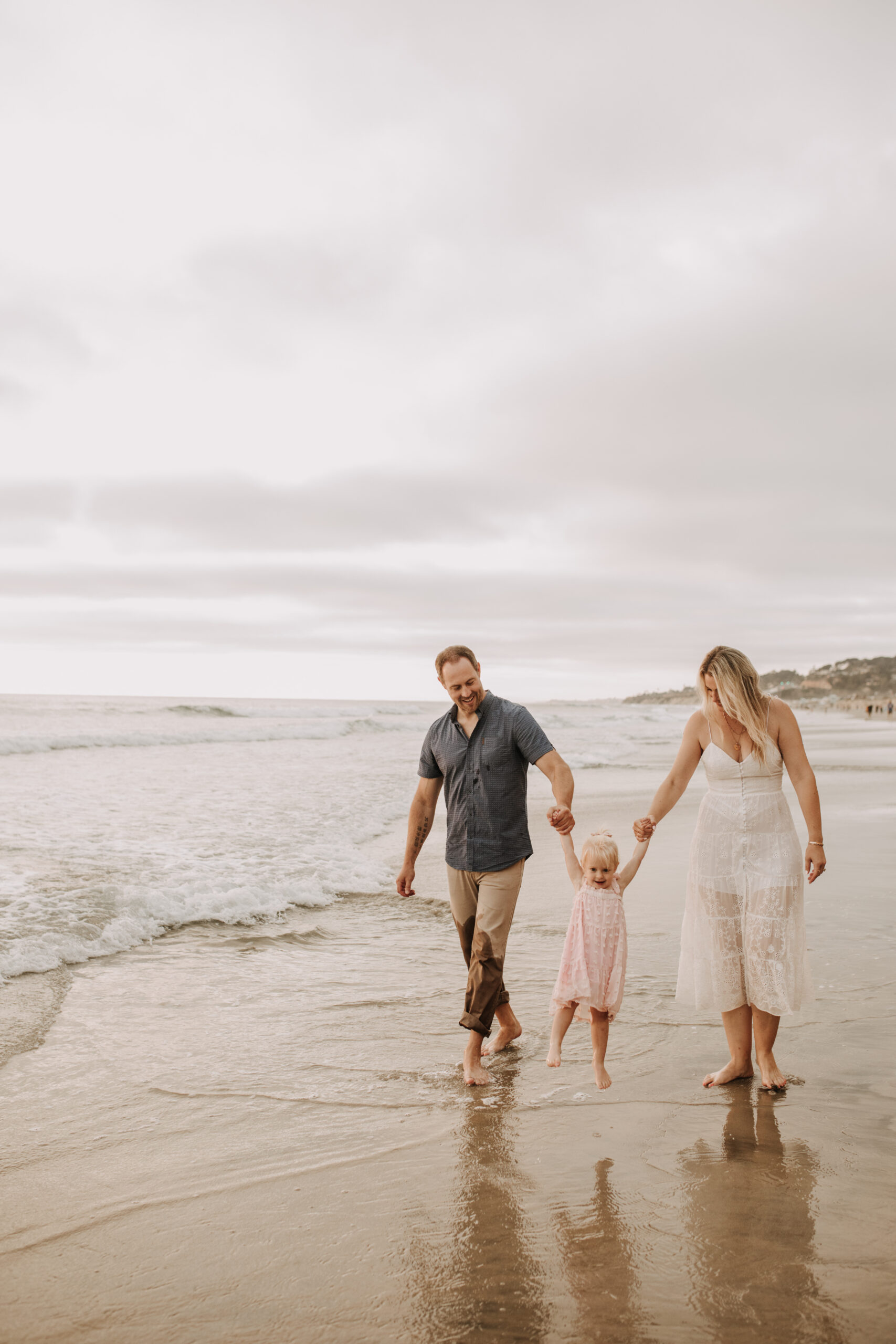 family photos on the beach sunset beach family dad mom baby water golden hour San Diego beach family photos San Diego family photographer