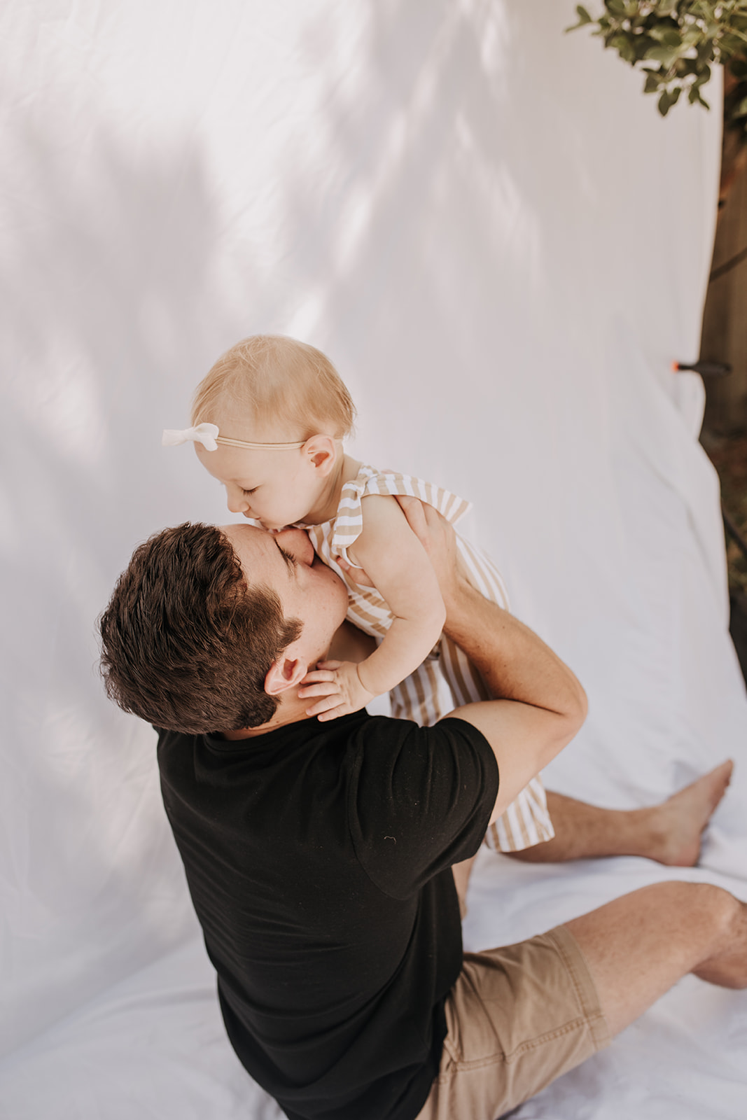 outdoor family photos San Diego family photographer candid family photos mom and dad and baby backyard mini session white backdrop photography