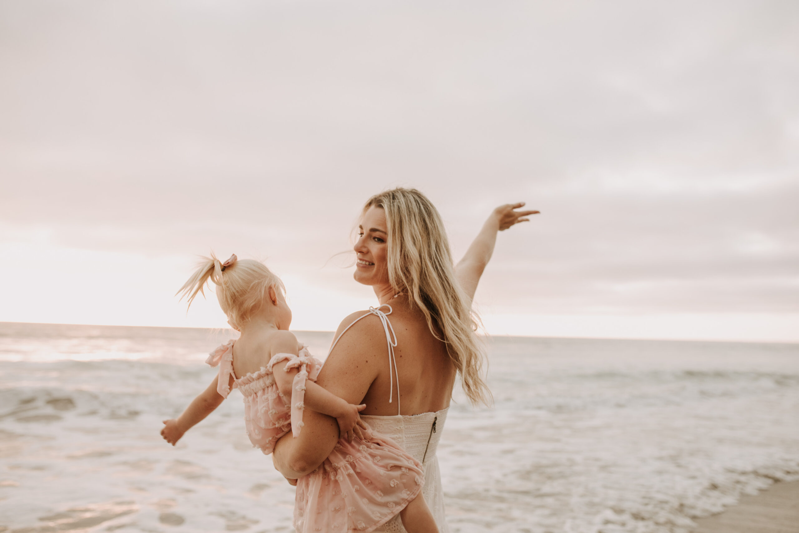 family photos on the beach sunset beach family dad mom baby water golden hour San Diego beach family photos San Diego family photographer