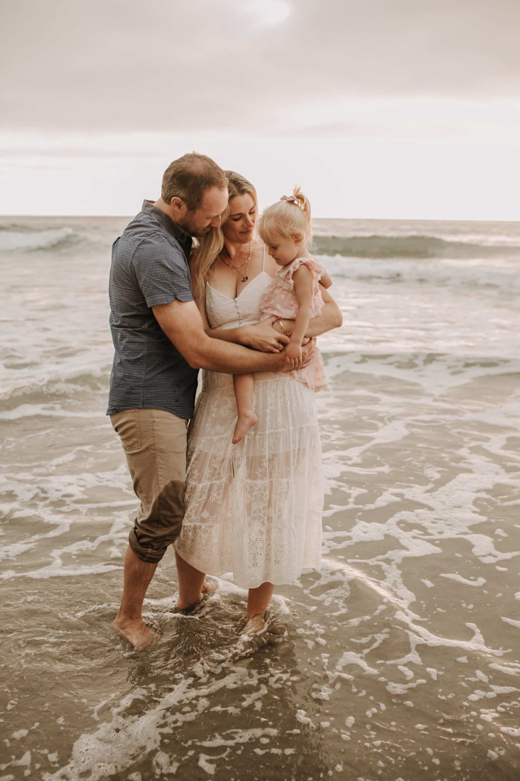 family photos on the beach sunset beach family dad mom baby water golden hour San Diego beach family photos San Diego family photographer