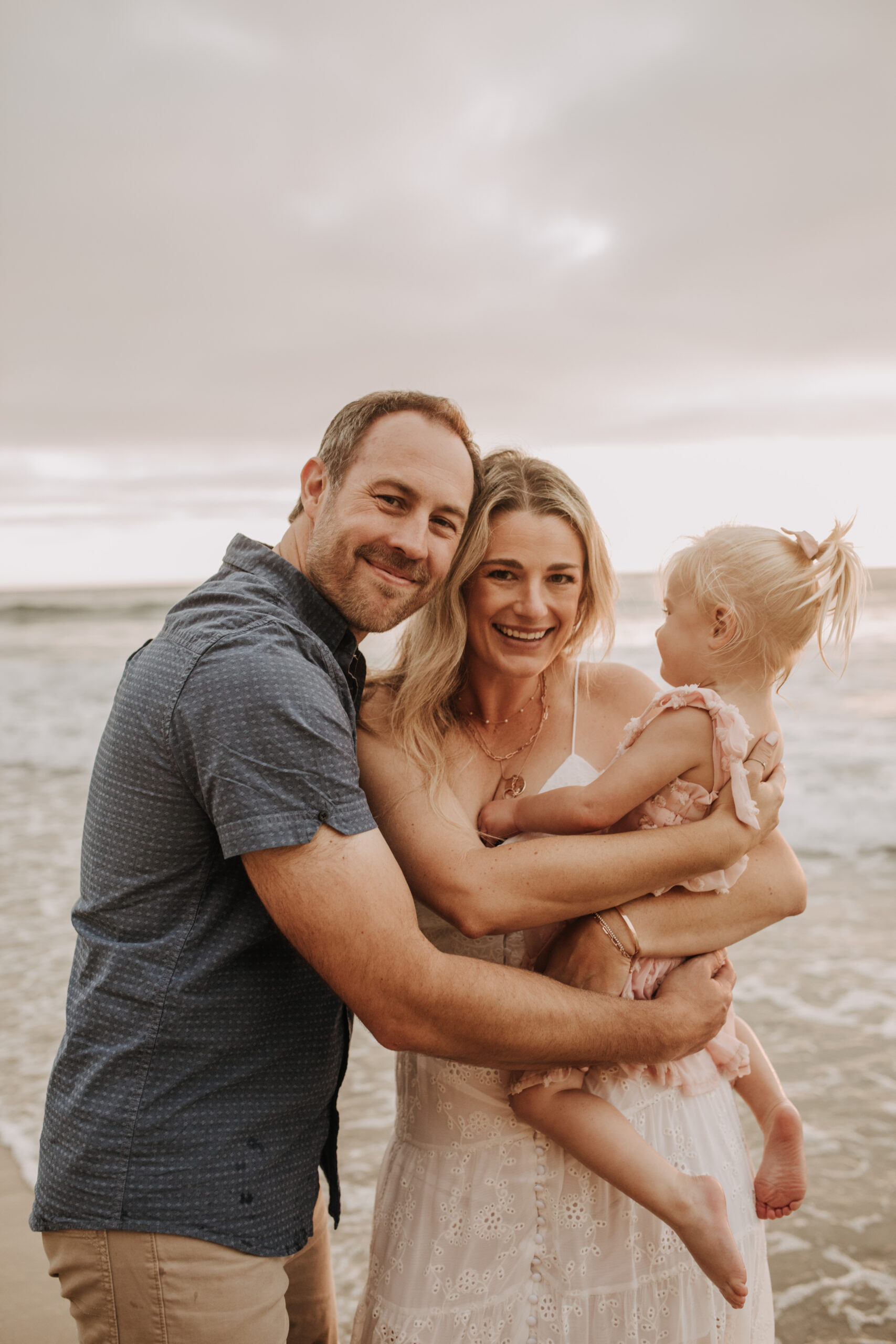 family photos on the beach sunset beach family dad mom baby water golden hour San Diego beach family photos San Diego family photographer