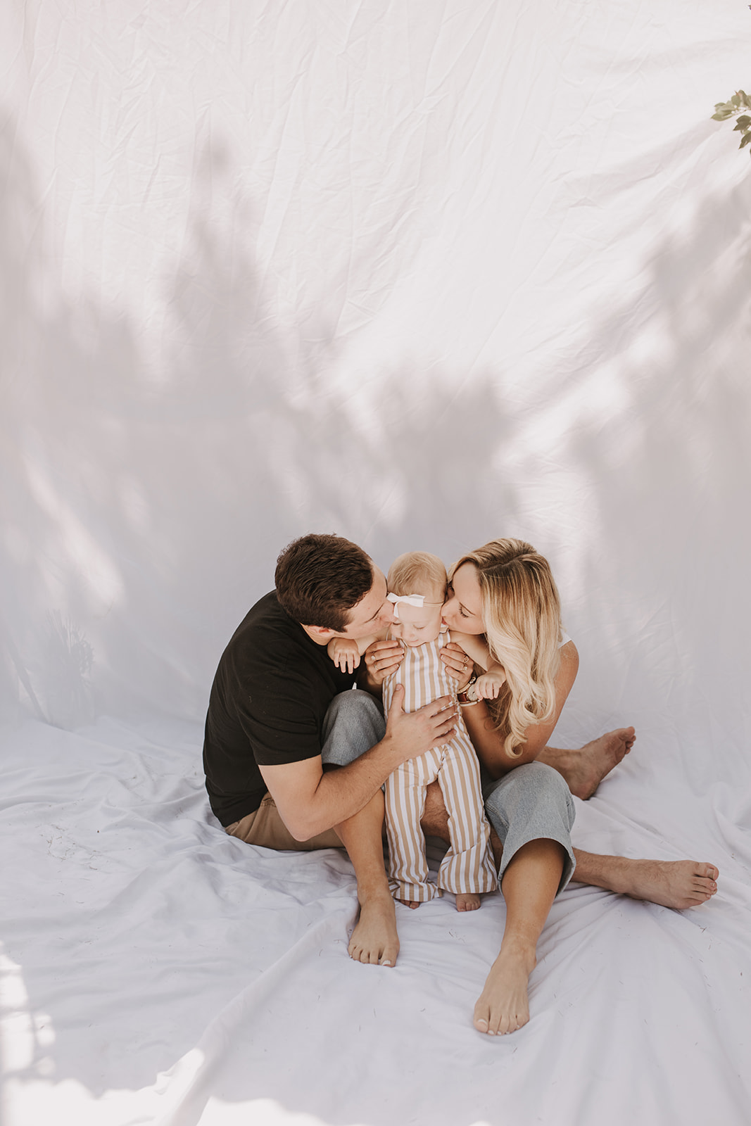 outdoor family photos San Diego family photographer candid family photos mom and dad and baby backyard mini session white backdrop photography