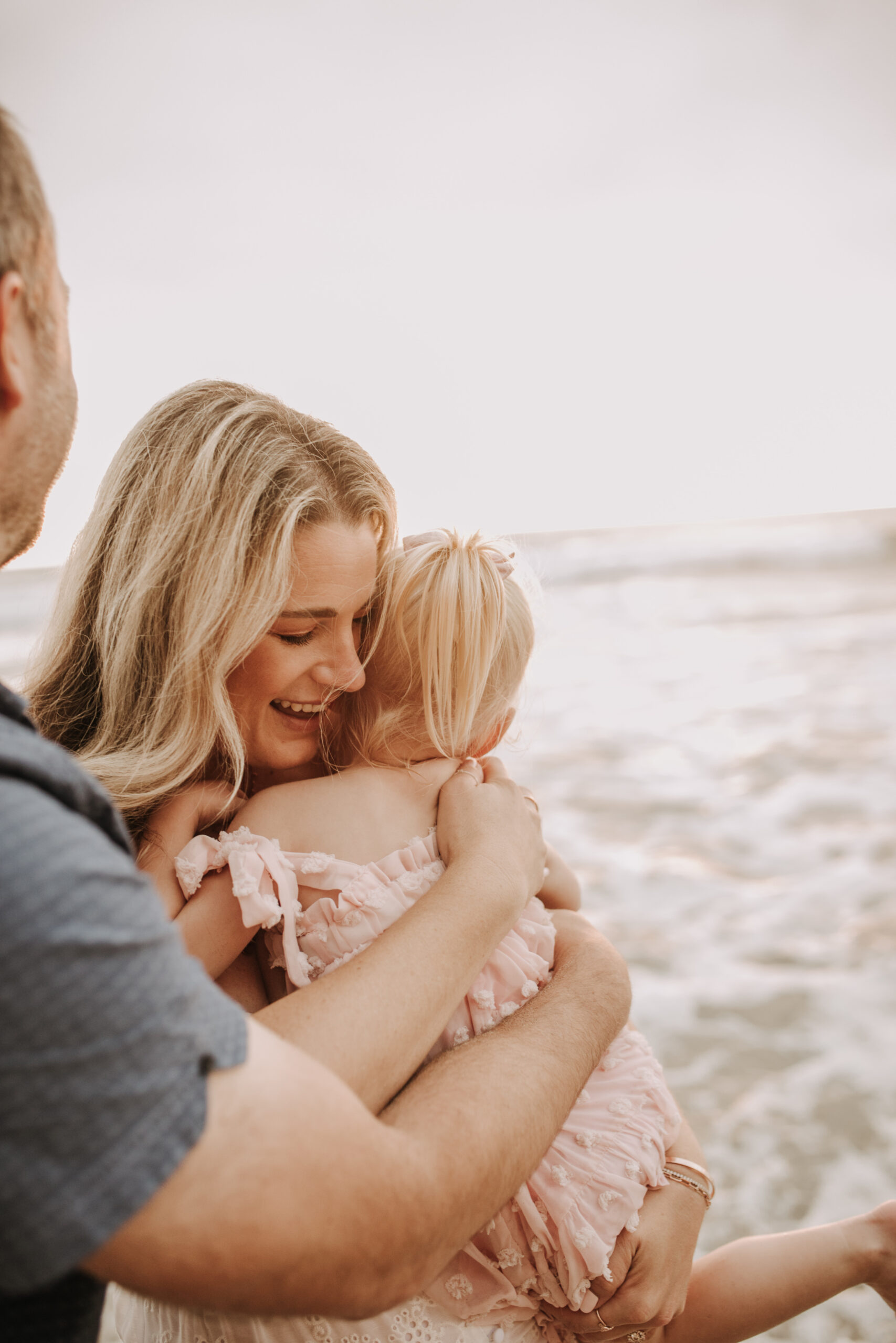 family photos on the beach sunset beach family dad mom baby water golden hour San Diego beach family photos San Diego family photographer