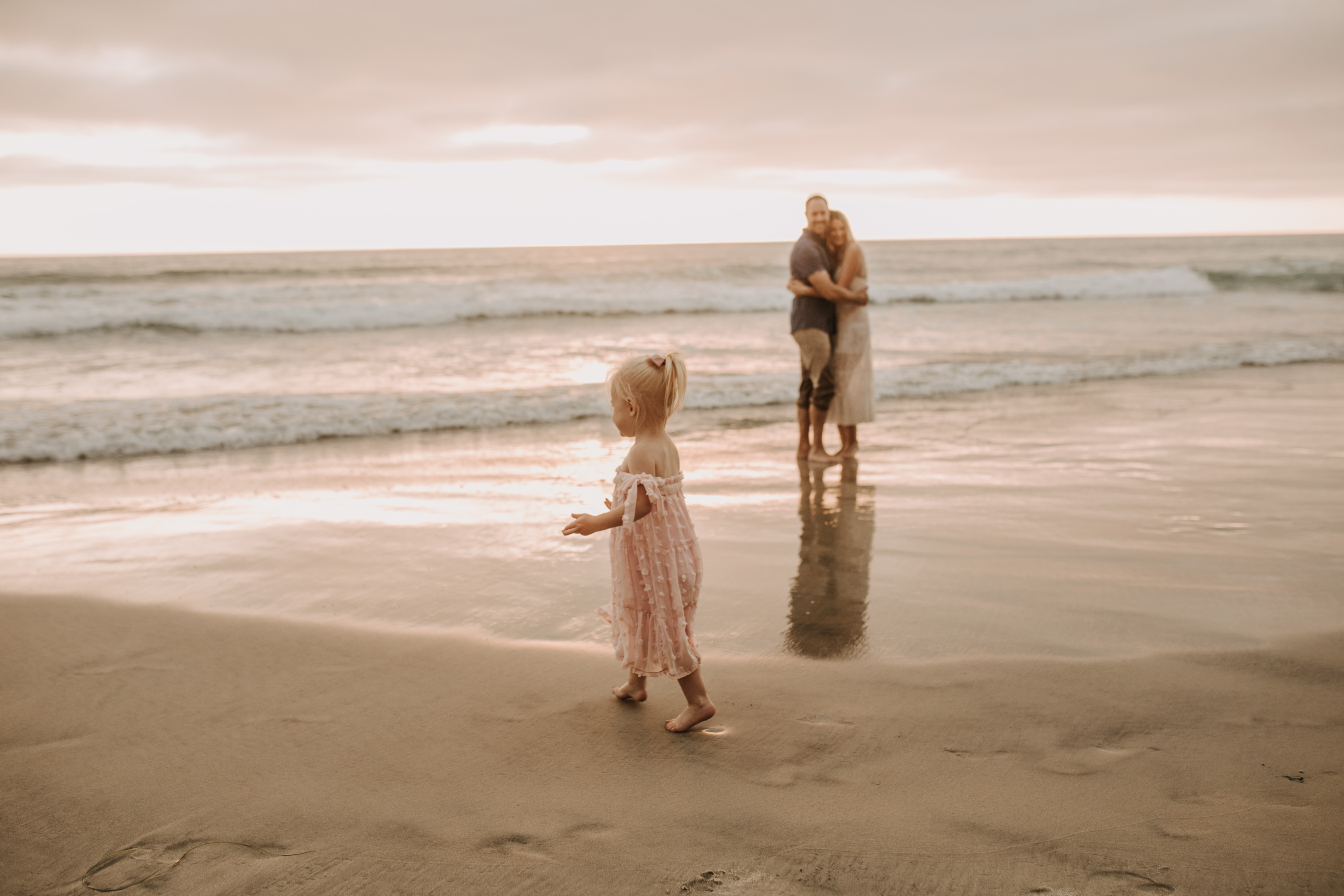 family photos on the beach sunset beach family dad mom baby water golden hour San Diego beach family photos San Diego family photographer