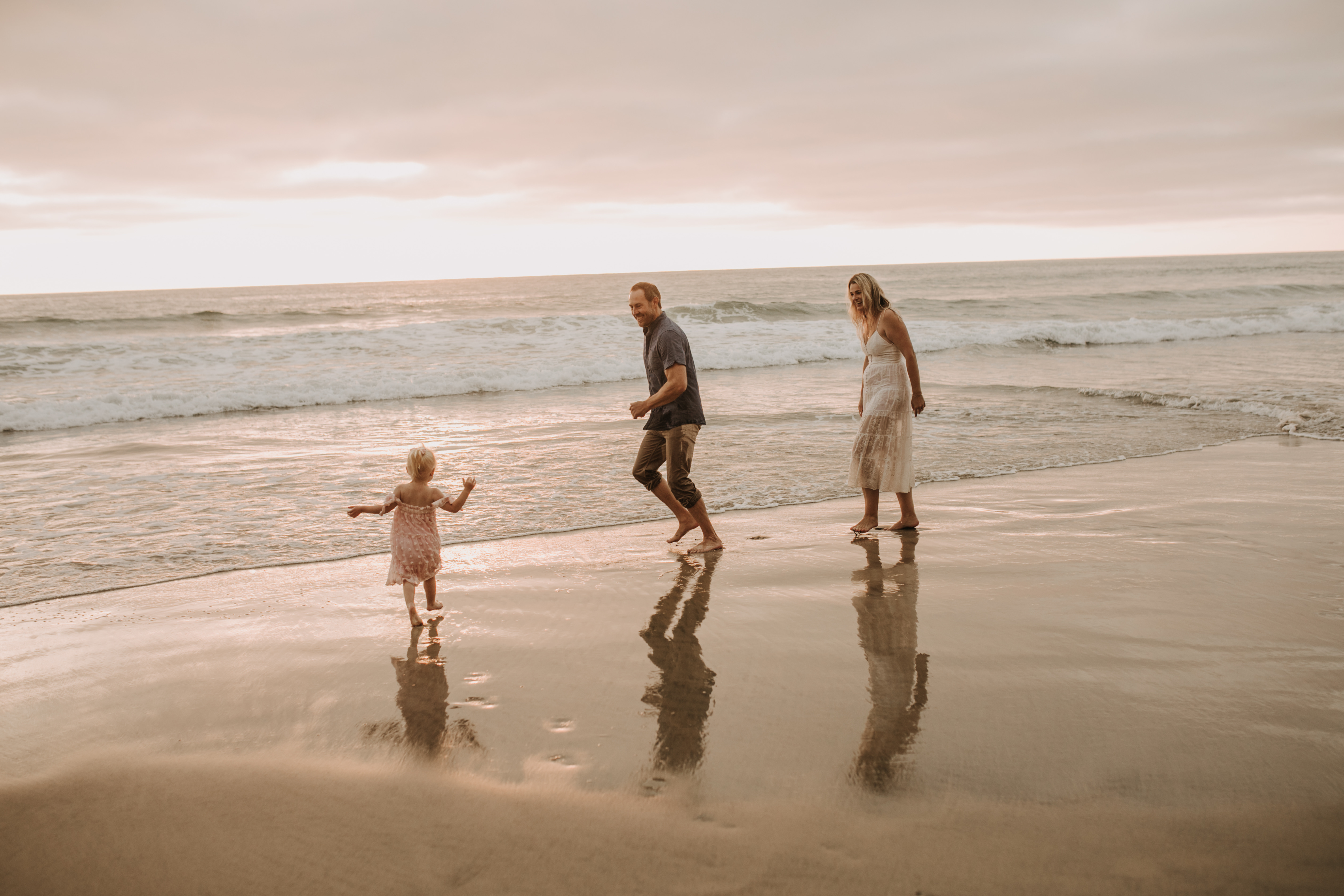 family photos on the beach sunset beach family dad mom baby water golden hour San Diego beach family photos San Diego family photographer