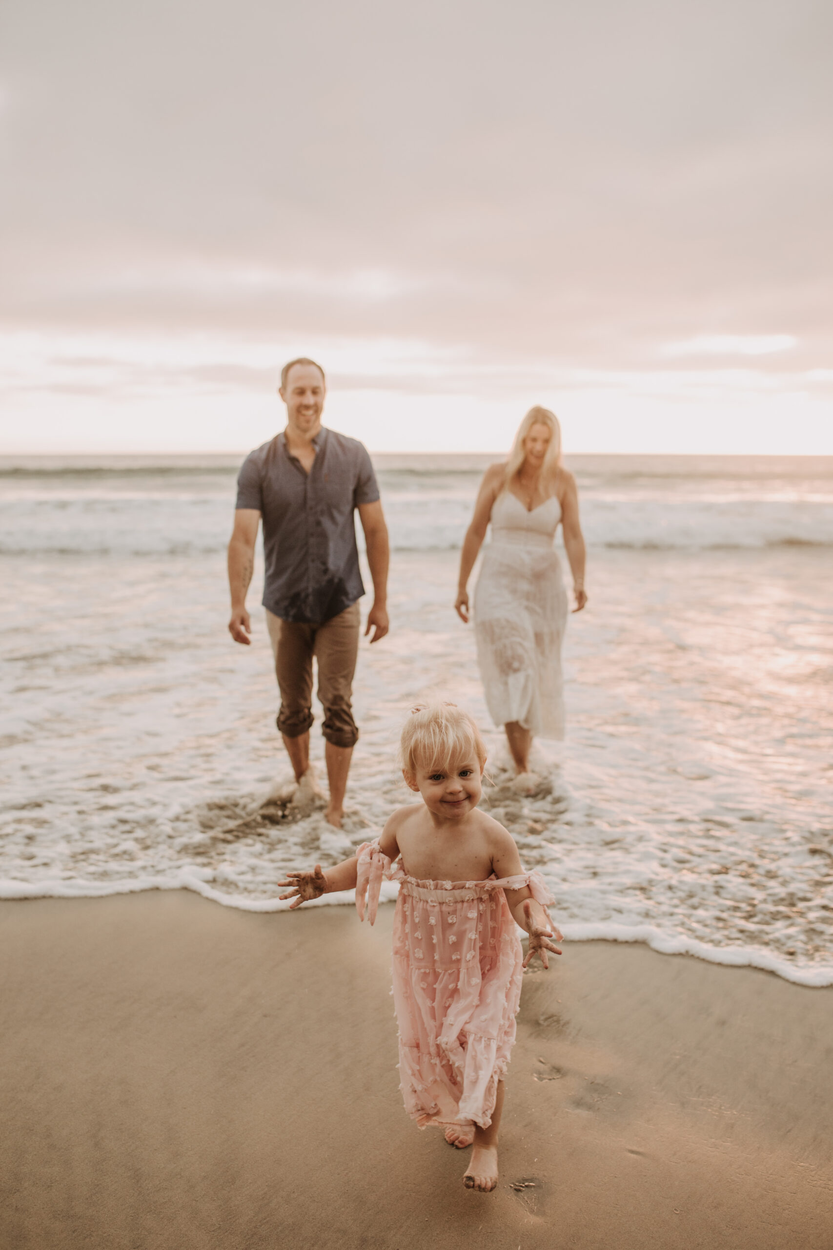 family photos on the beach sunset beach family dad mom baby water golden hour San Diego beach family photos San Diego family photographer