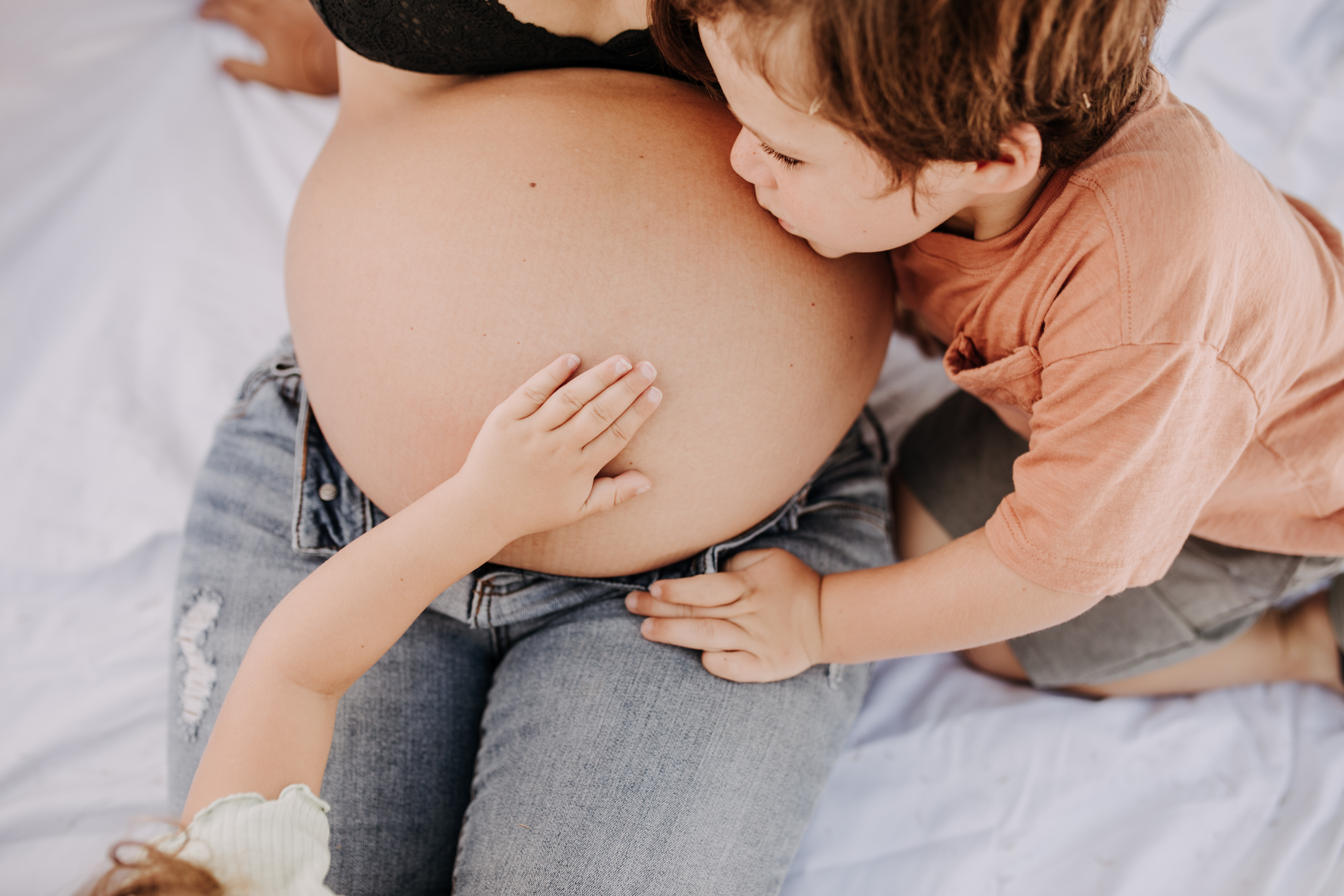 backyard mini session family photos white backdrop outdoor motherhood maternity san diego family photographer