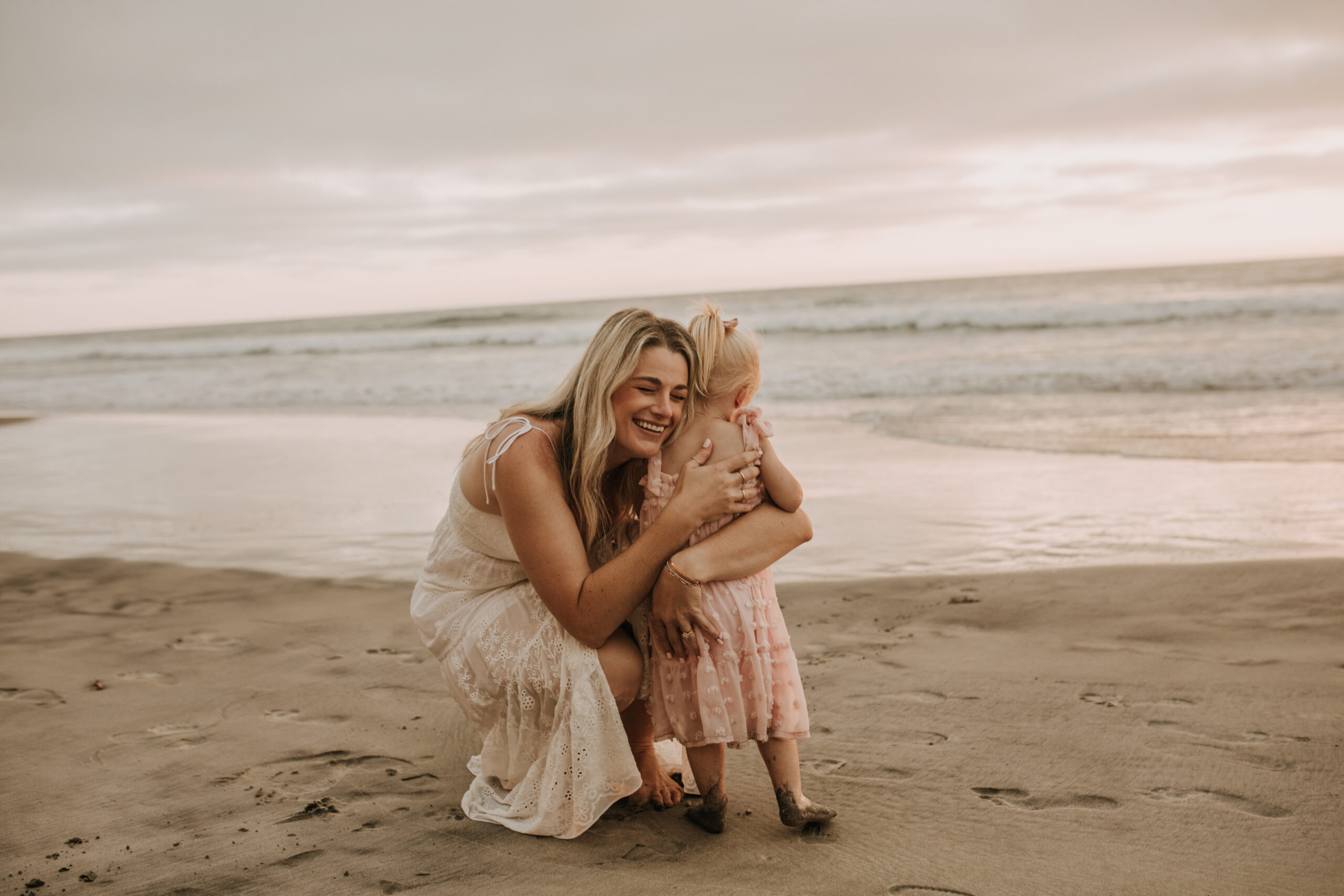 family photos on the beach sunset beach family dad mom baby water golden hour San Diego beach family photos San Diego family photographer