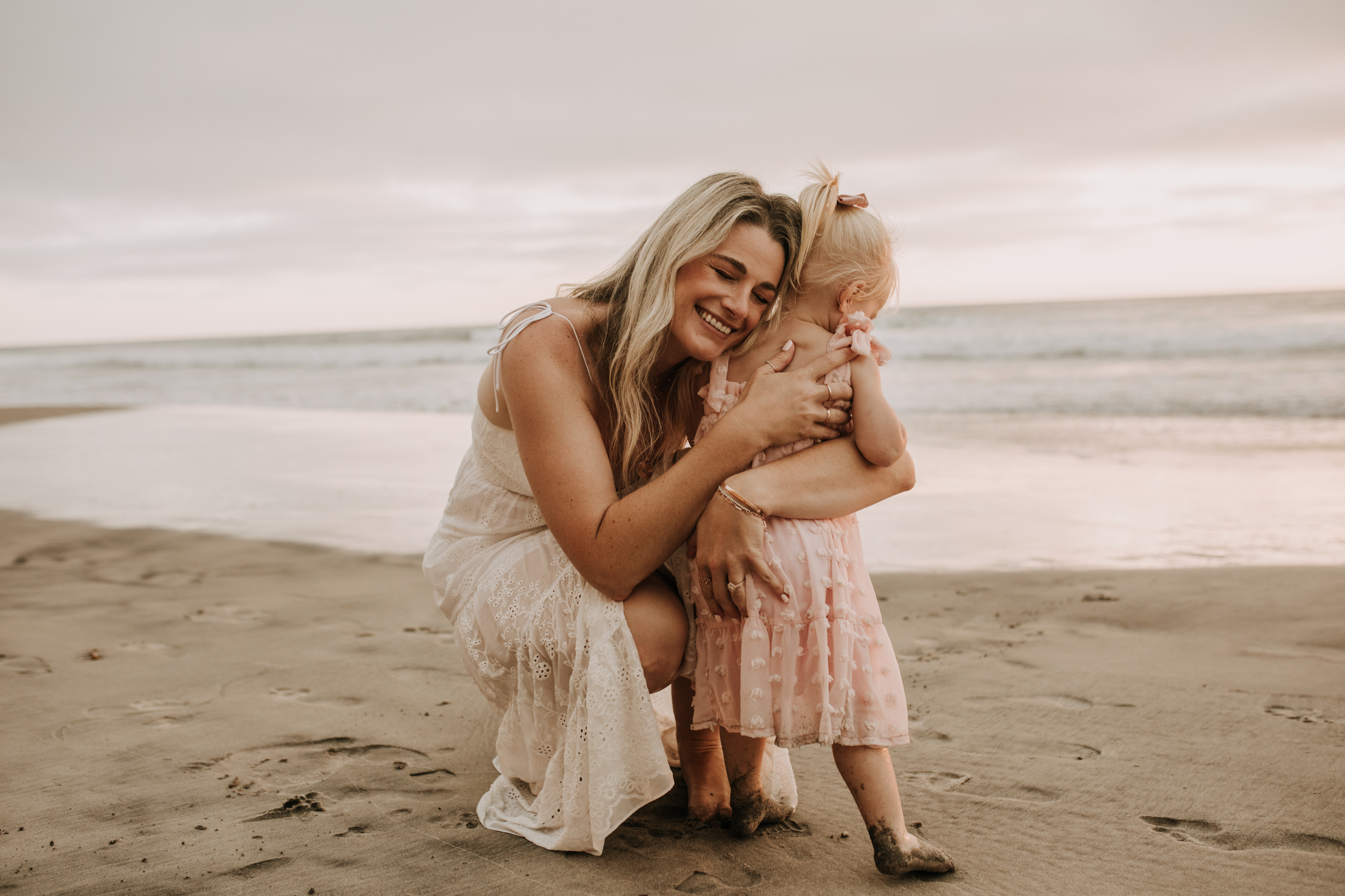 family photos on the beach sunset beach family dad mom baby water golden hour San Diego beach family photos San Diego family photographer