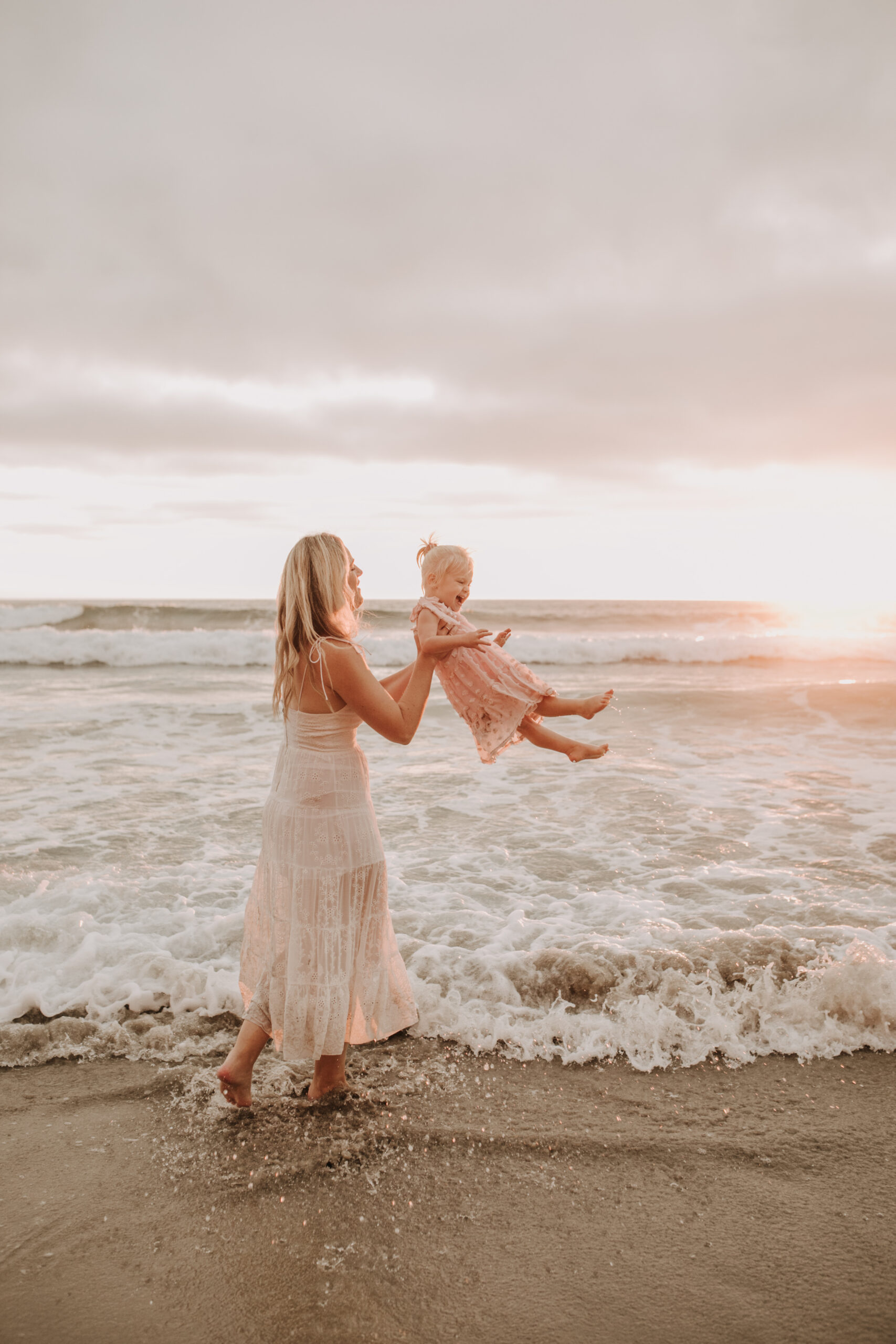 family photos on the beach sunset beach family dad mom baby water golden hour San Diego beach family photos San Diego family photographer