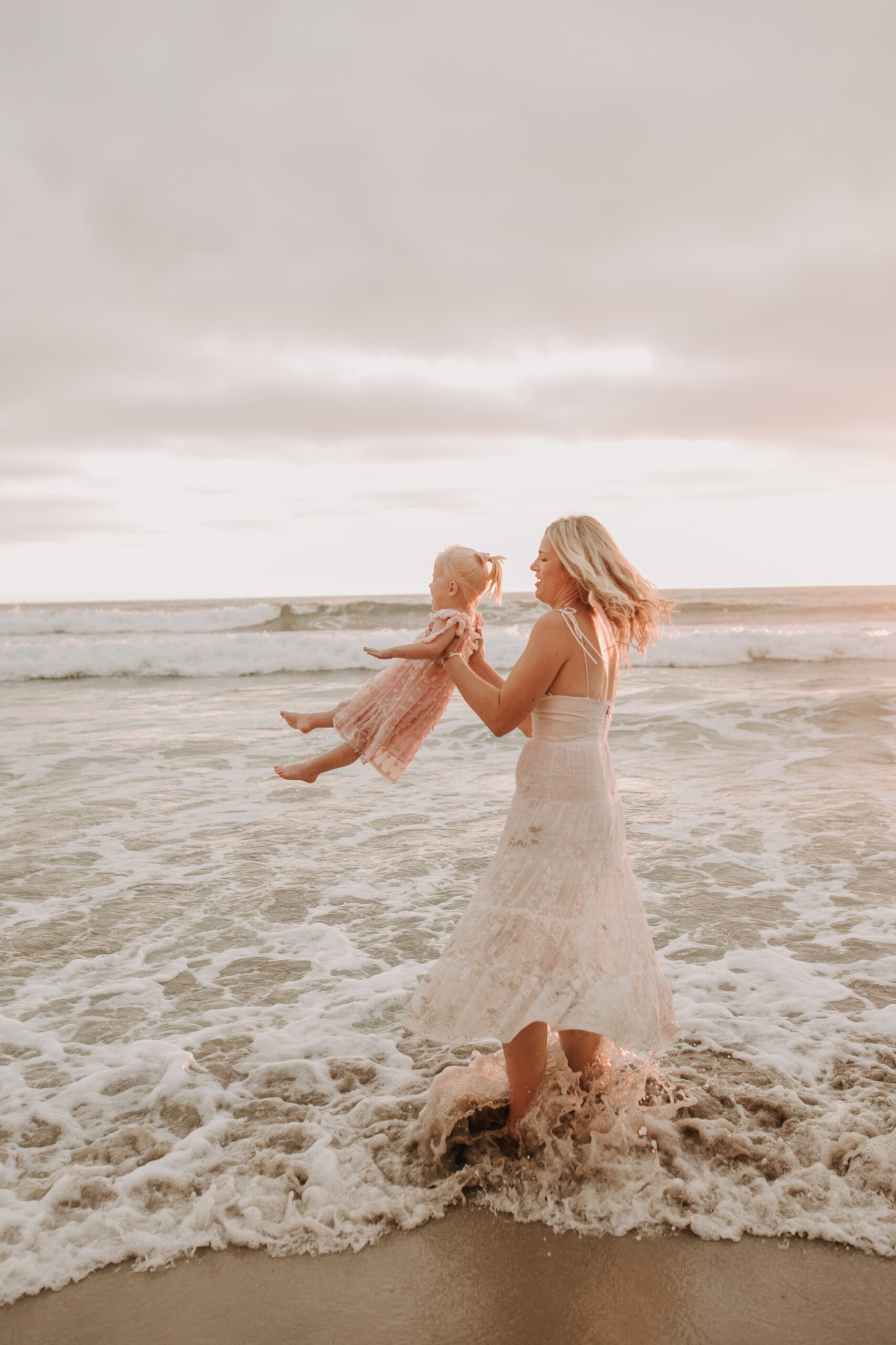 family photos on the beach sunset beach family dad mom baby water golden hour San Diego beach family photos San Diego family photographer