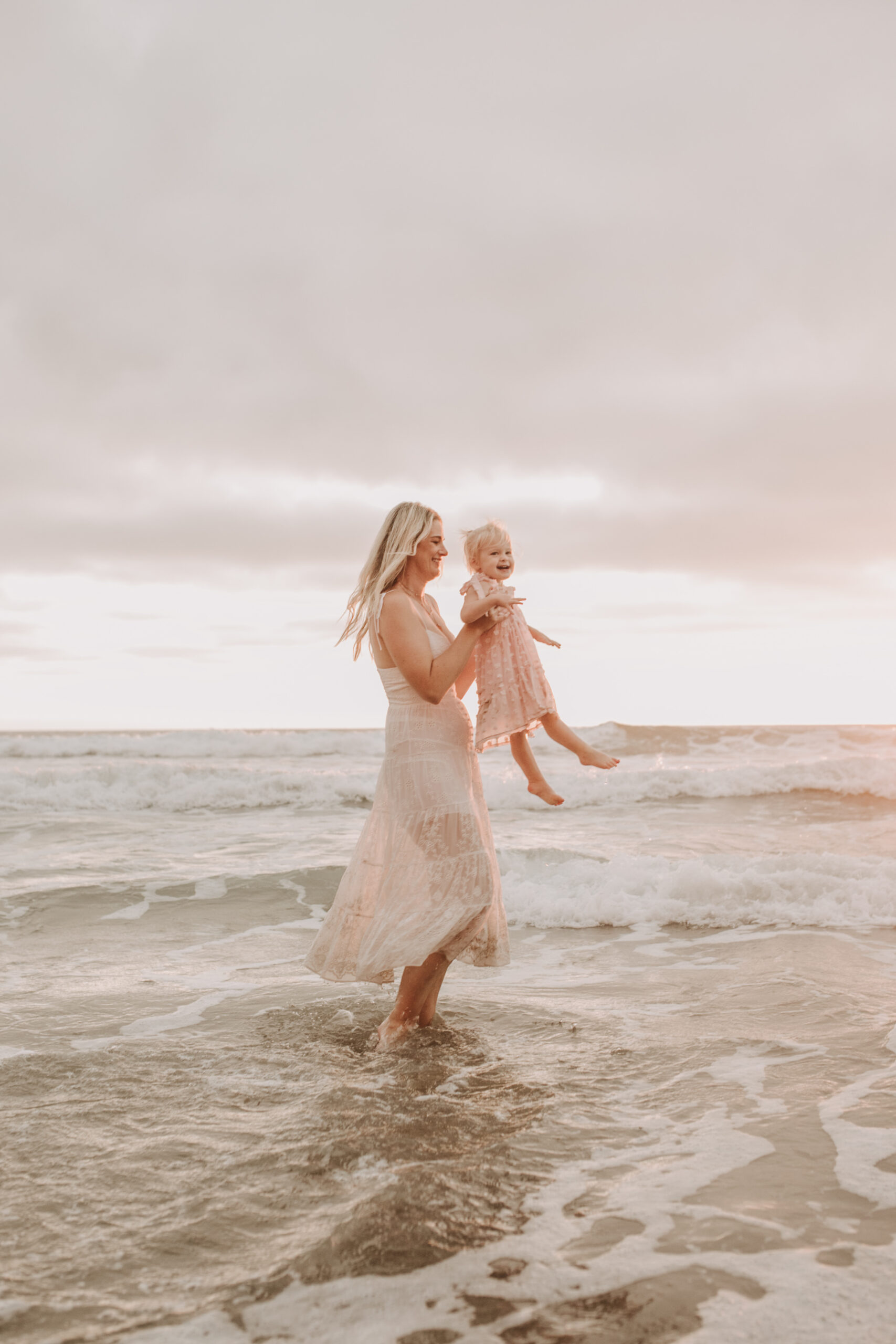 family photos on the beach sunset beach family dad mom baby water golden hour San Diego beach family photos San Diego family photographer