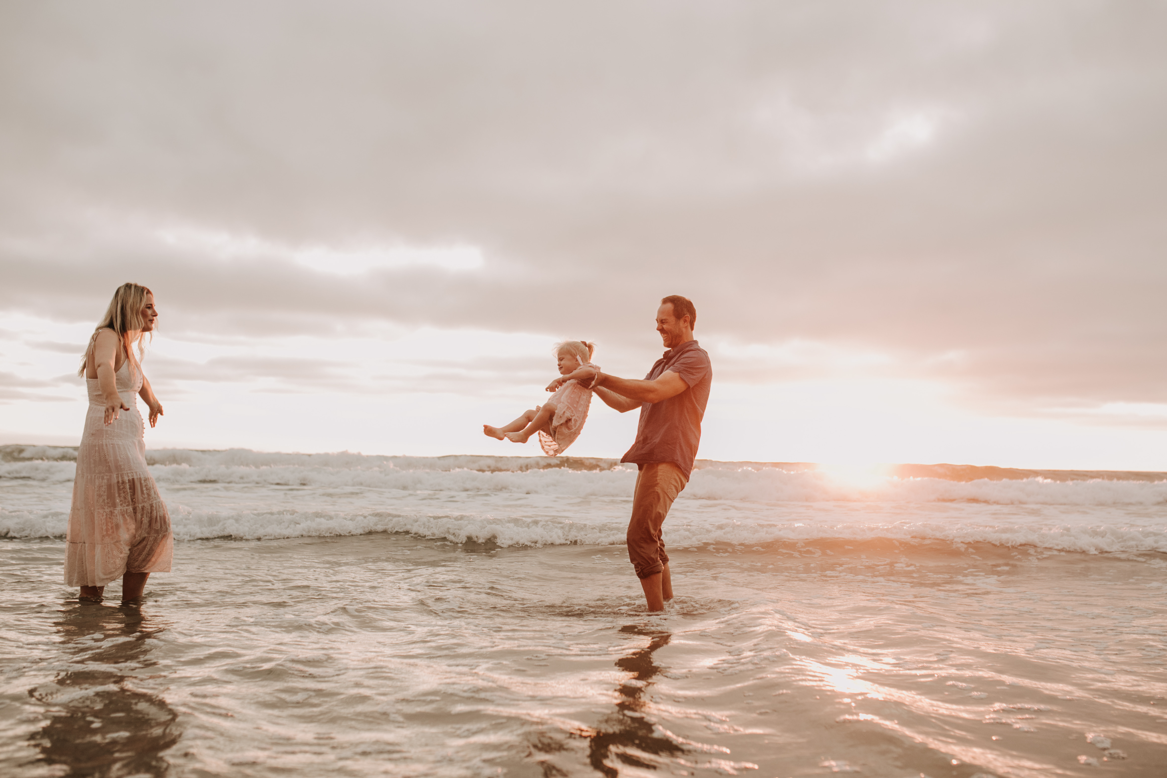 family photos on the beach sunset beach family dad mom baby water golden hour San Diego beach family photos San Diego family photographer