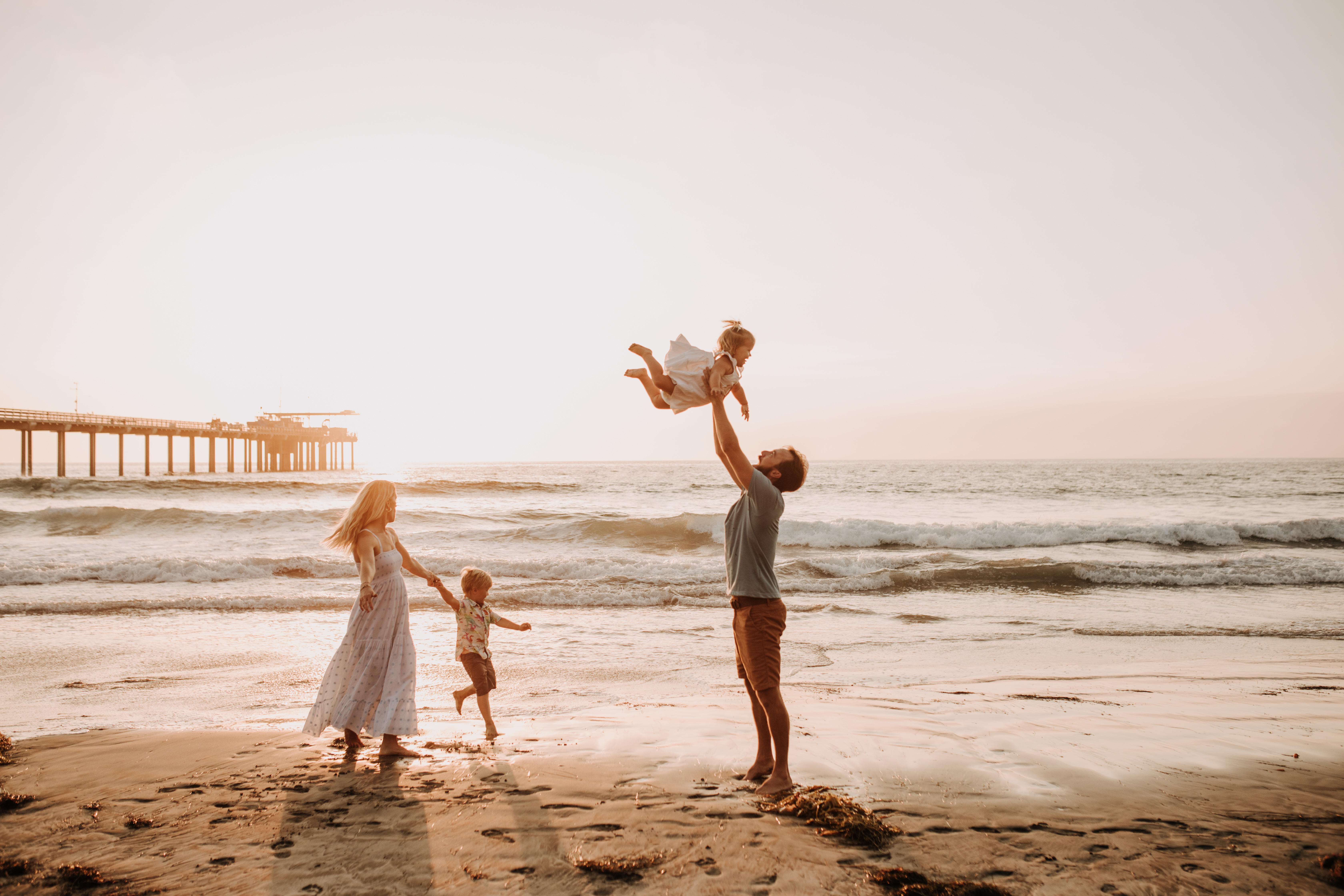 Family photos on the beach cool blue toned family photos San Diego photography family of four candid family moments family love beach family photos San Diego family photographer Sabrinalynnphoto