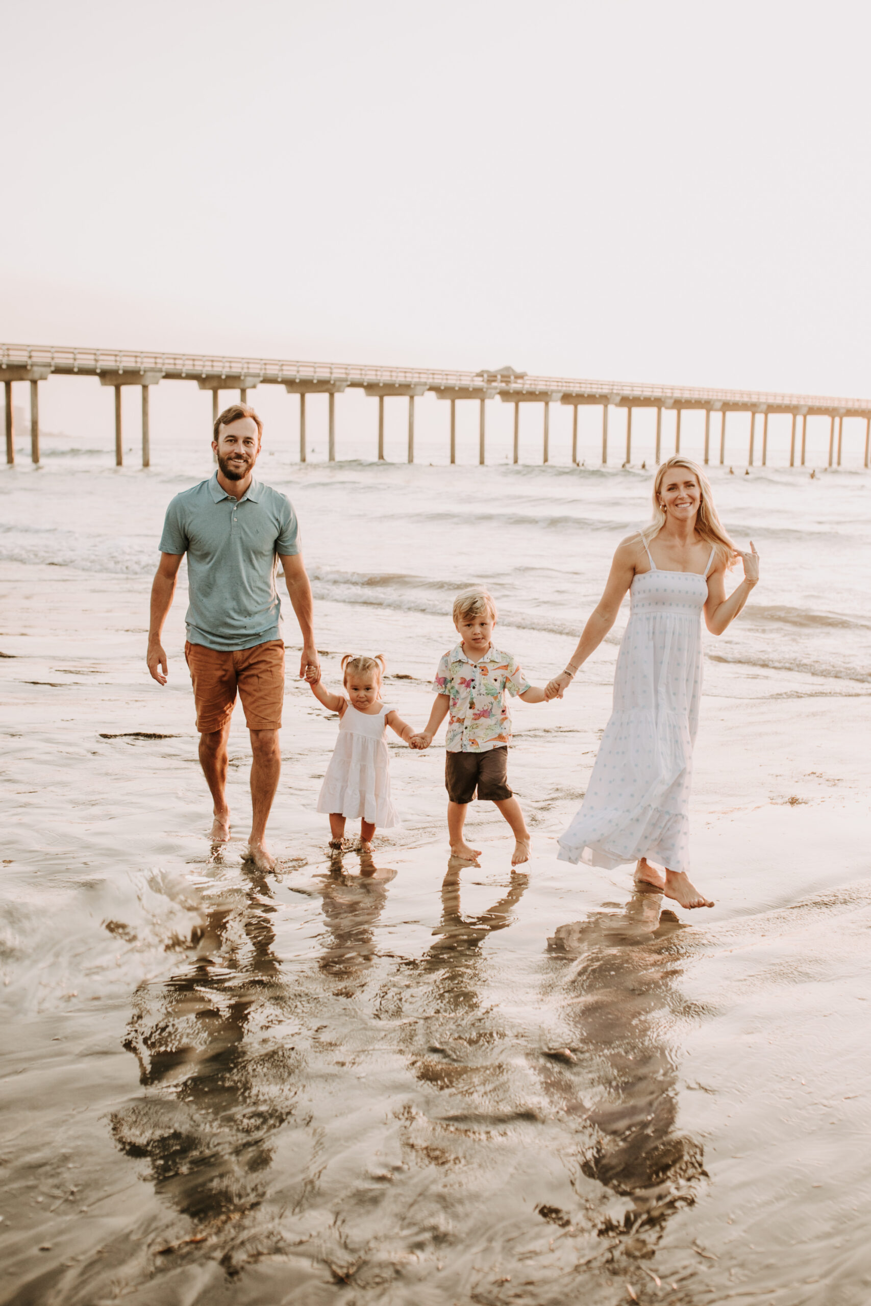 Family photos on the beach cool blue toned family photos San Diego photography family of four candid family moments family love beach family photos San Diego family photographer Sabrinalynnphoto