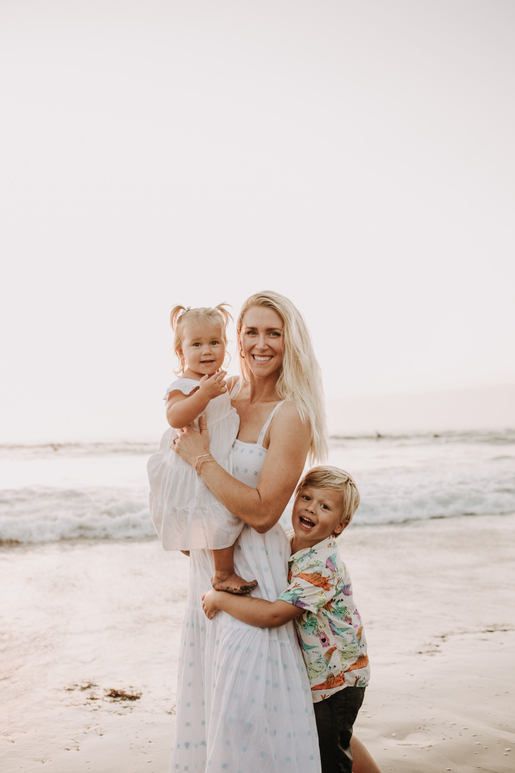 Family photos on the beach cool blue toned family photos San Diego photography family of four candid family moments family love beach family photos San Diego family photographer Sabrinalynnphoto