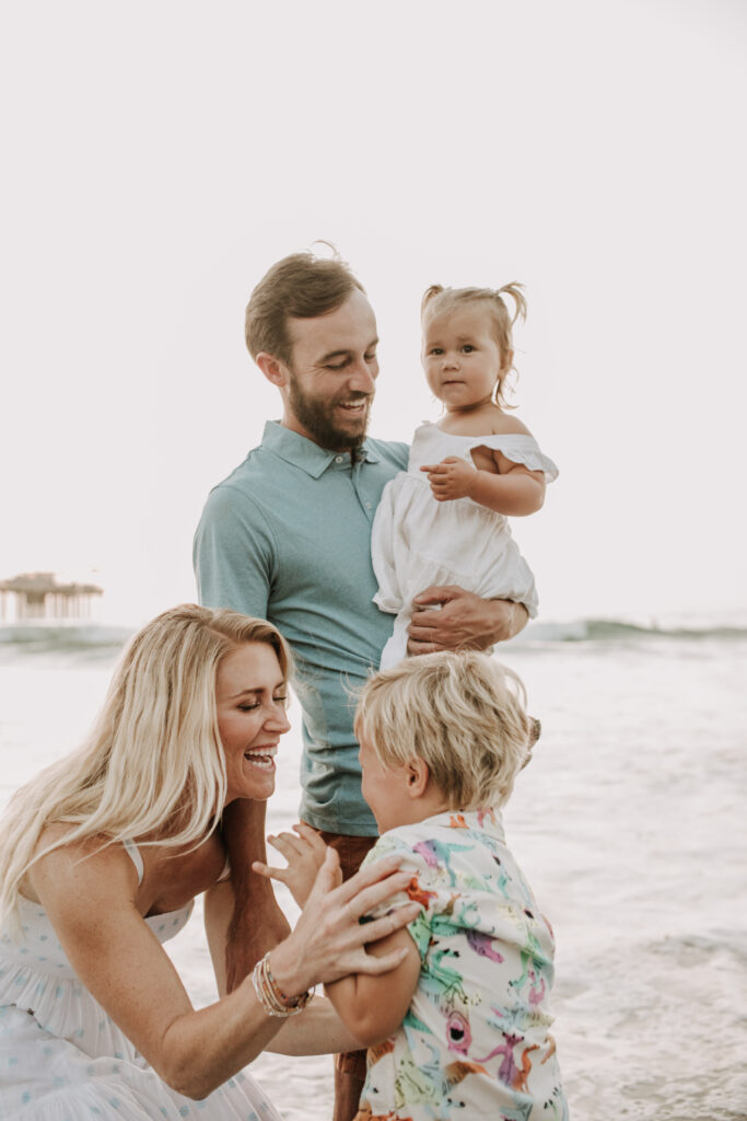 Family photos on the beach cool blue toned family photos San Diego photography family of four candid family moments family love beach family photos San Diego family photographer Sabrinalynnphoto