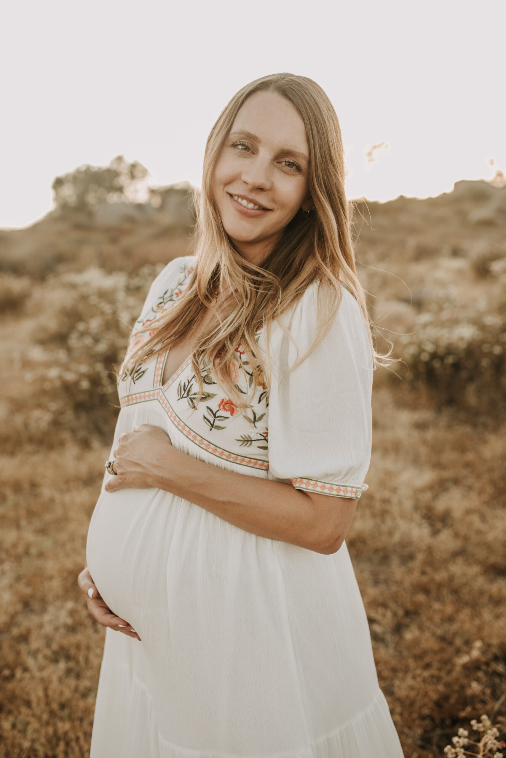 outdoor maternity photos warm and sunny maternity photos couples photos summer field white dress pregnancy San Diego photographer Sabrina kinsella