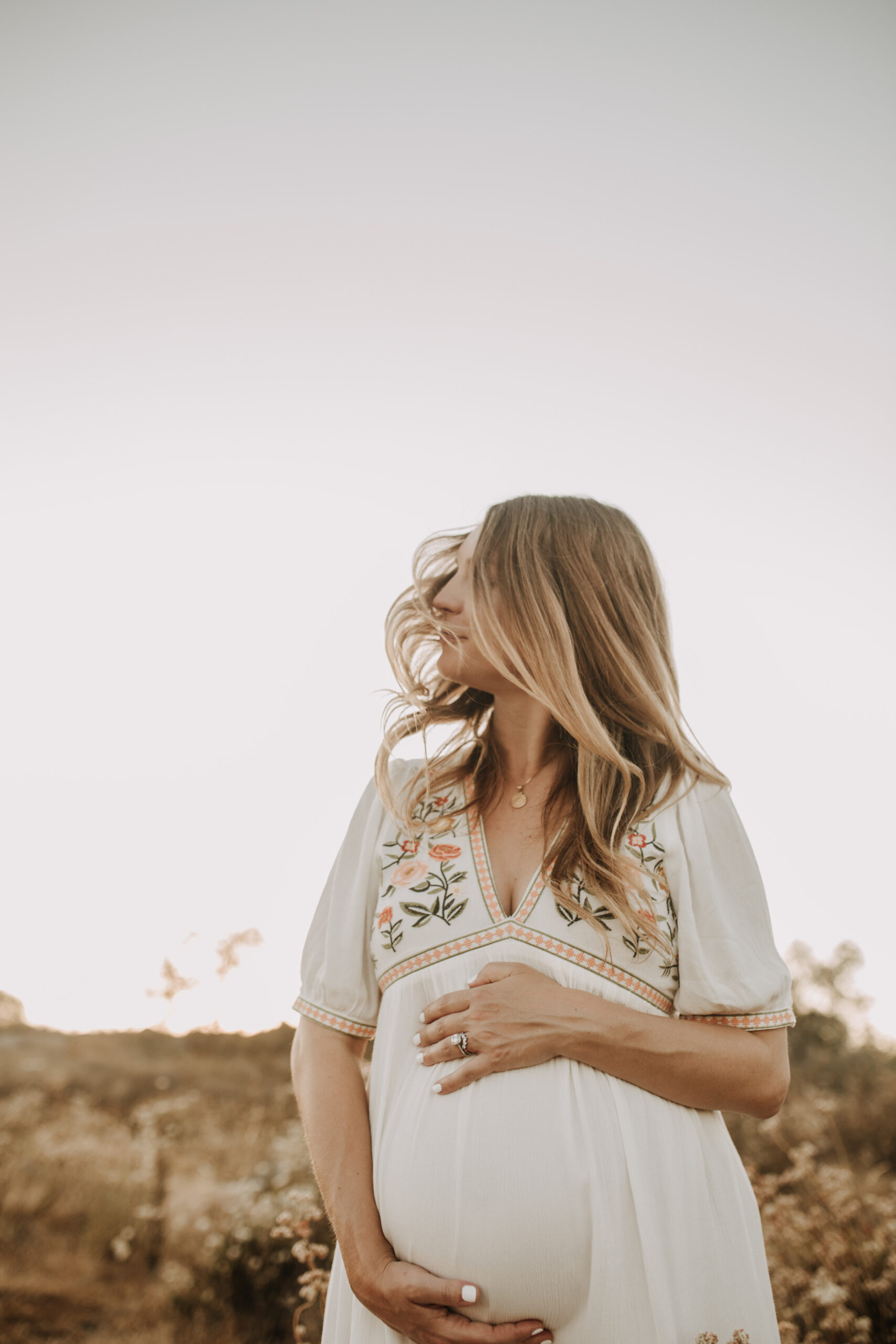 outdoor maternity photos warm and sunny maternity photos couples photos summer field white dress pregnancy San Diego photographer Sabrina kinsella