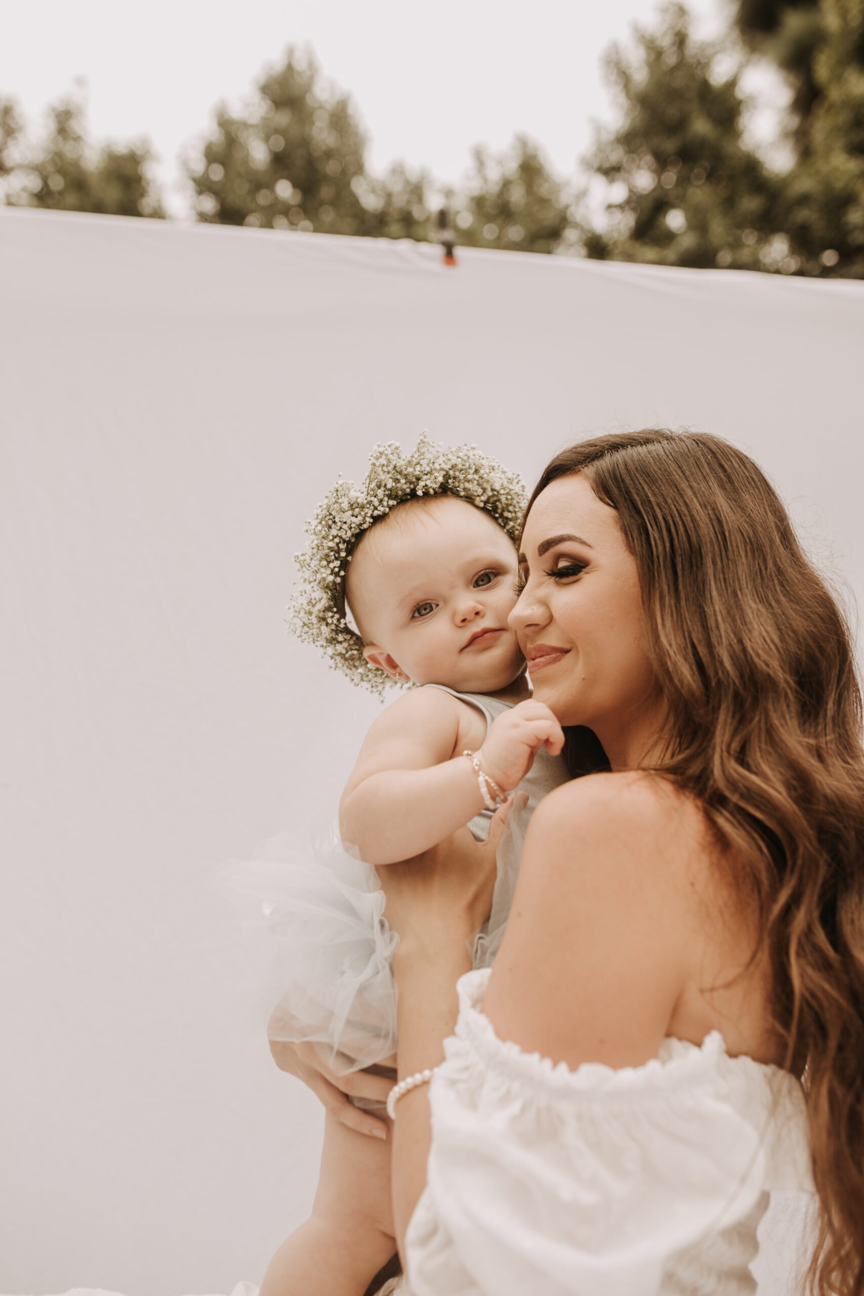 springtime soft light daisies mama and me mom and baby white dress white backdrop flower crown motherhood photos motherhood photography San Diego maternity photographer family photographer Sabrina kinsella outdoor photos green trees backyard mini session