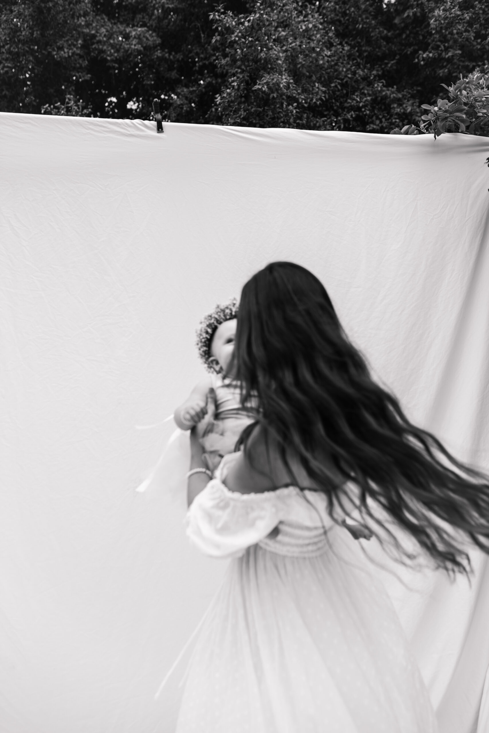 springtime soft light daisies mama and me mom and baby white dress white backdrop flower crown motherhood photos motherhood photography San Diego maternity photographer family photographer Sabrina kinsella outdoor photos green trees backyard mini session