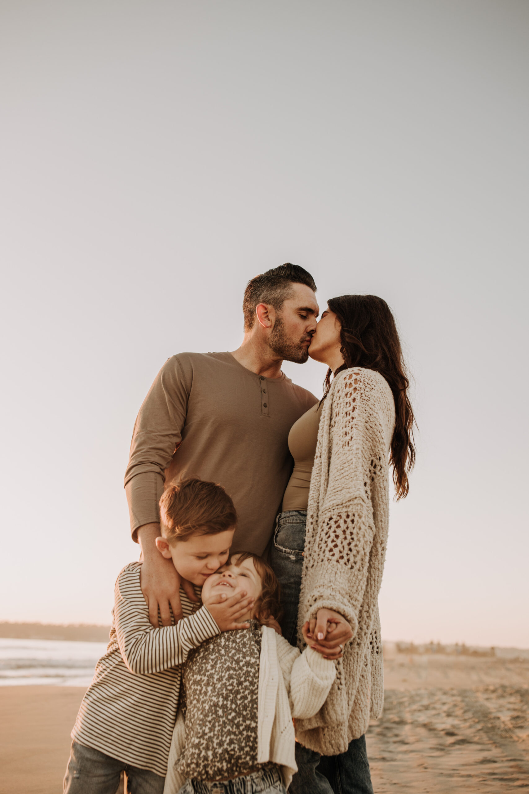 warm neutral sunset beach photos family photos on the beach golden hour family of four candid family photos love San Diego family photographer Sabrina kinsella