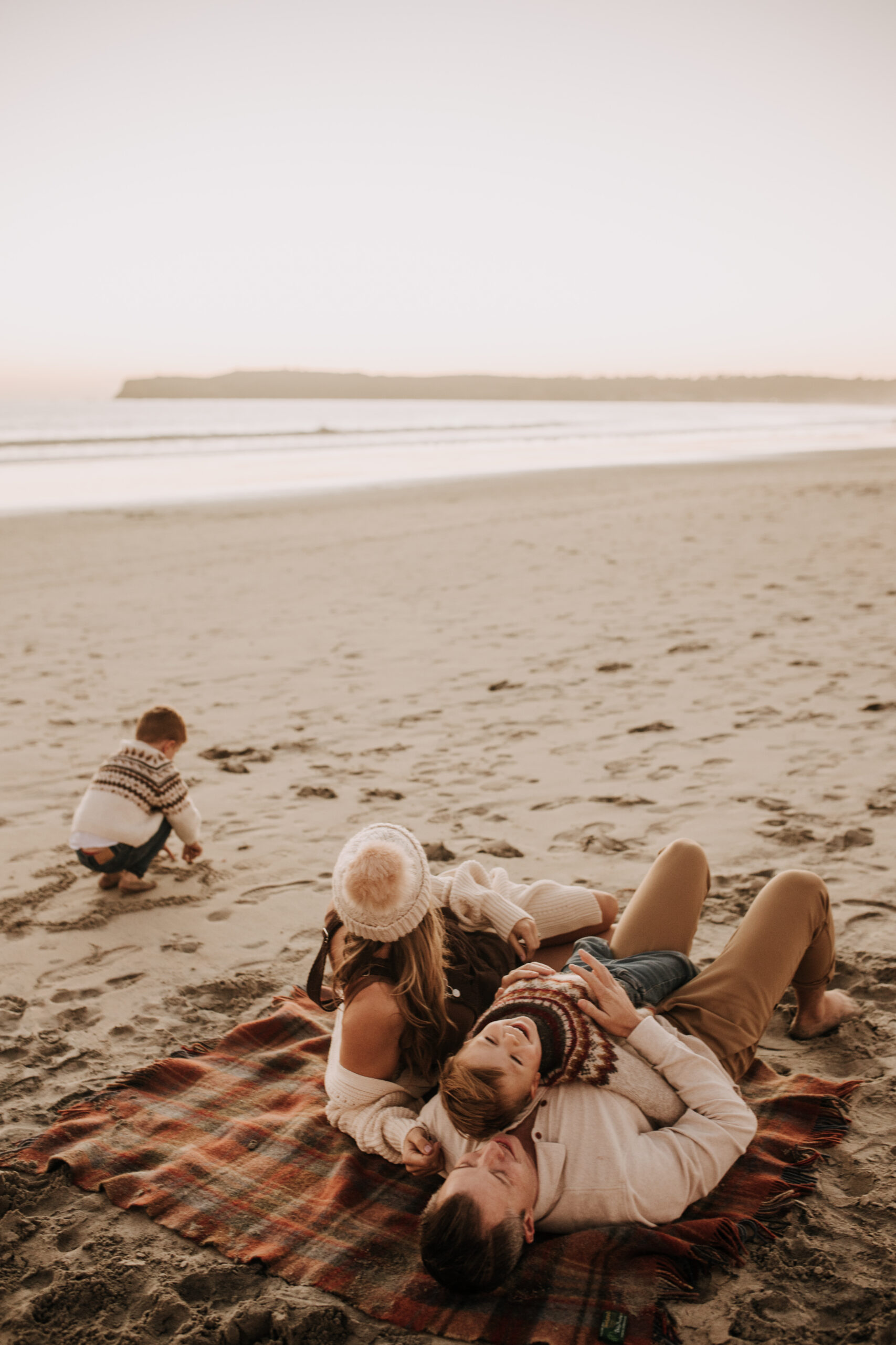 San Diego family photos warm sunset beach photos family of four candid family moments golden hour light beach San Diego family photographer Sabrina Kinsella